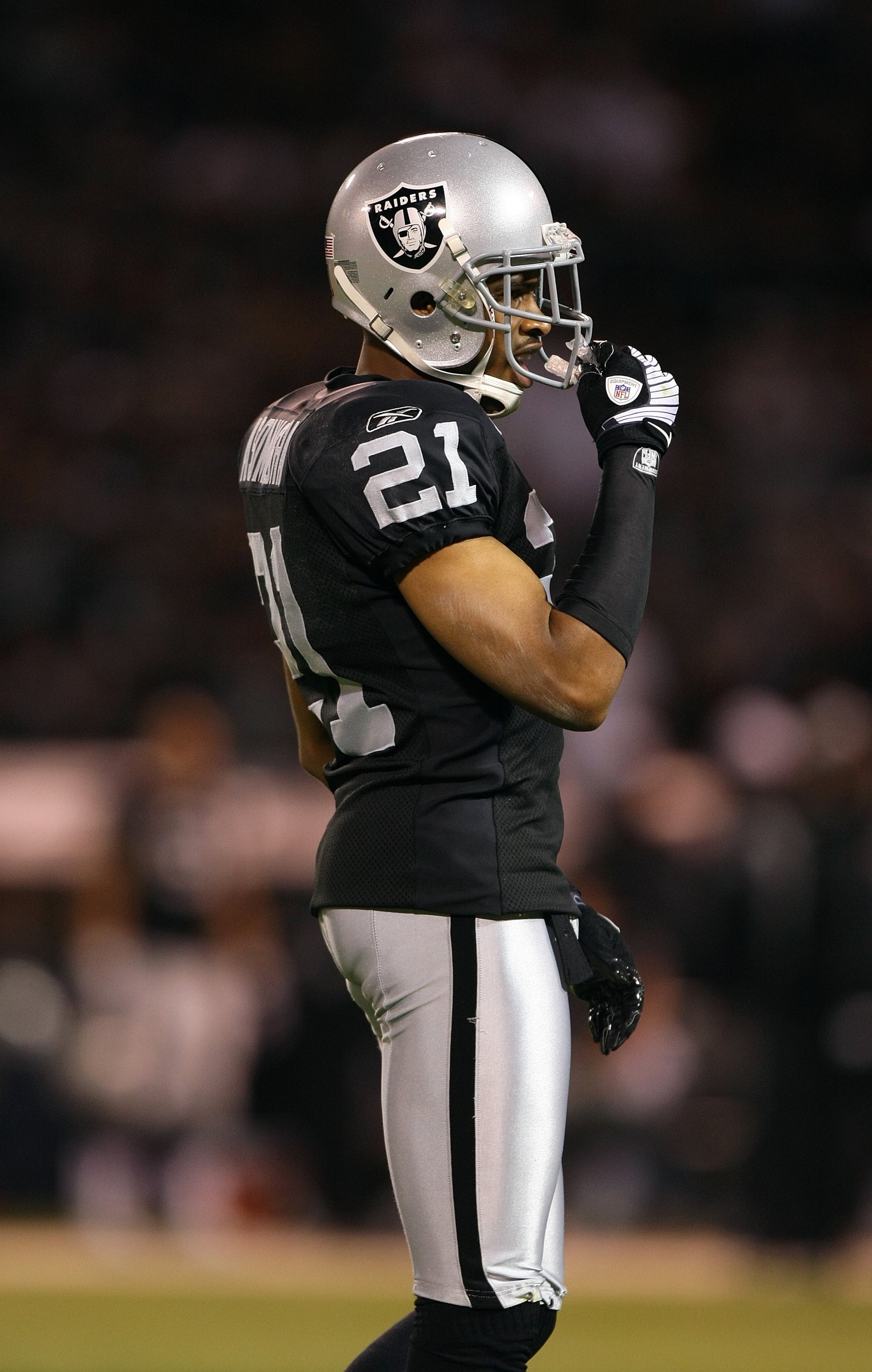 OAKLAND, CA - SEPTEMBER 8:  Nnamdi Asamugha #21 of the Oakland Raiders lines up in position during the NFL game against the Denver Broncos on September 8, 2008 at McAfee Coliseum in Oakland, California. The Broncos defeated the Raiders 41-14. (Photo by Je