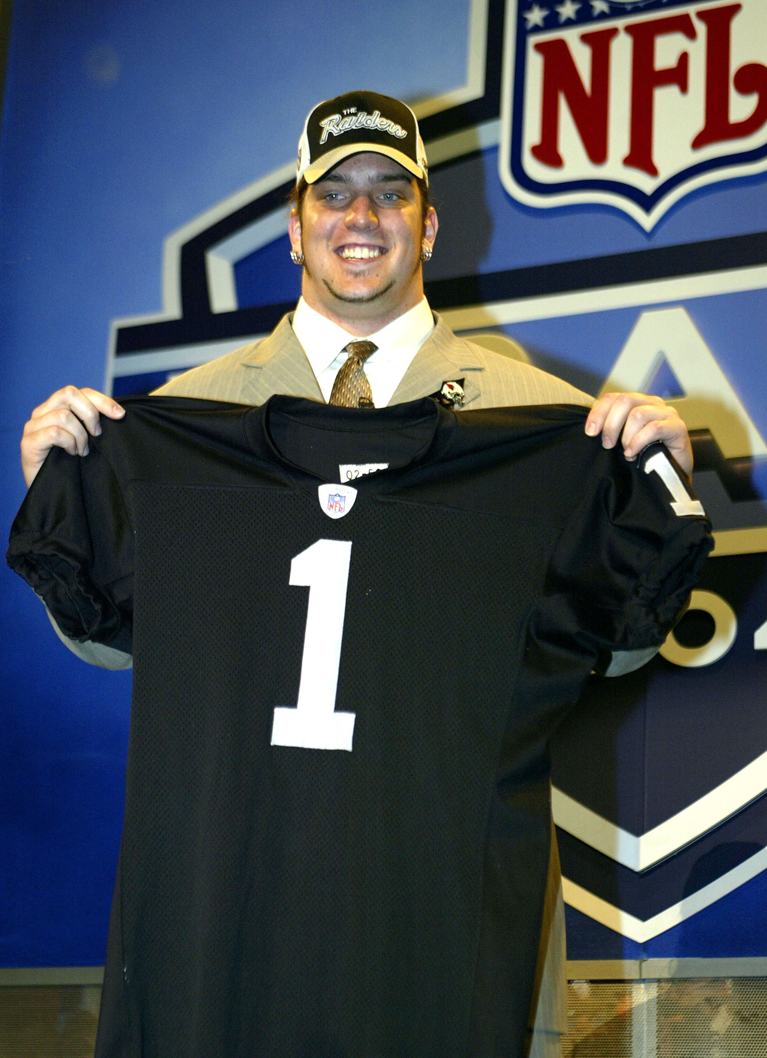 NEW YORK - APRIL 24:  Robert Gallery holds up his Oakland Raiders jersey during the 2004 NFL Draft on April 24, 2004 at Madison Square Garden in New York City. Gallery was selected second overall by the Oakland Raiders.  (Photo by Chris Trotman/Getty Imag