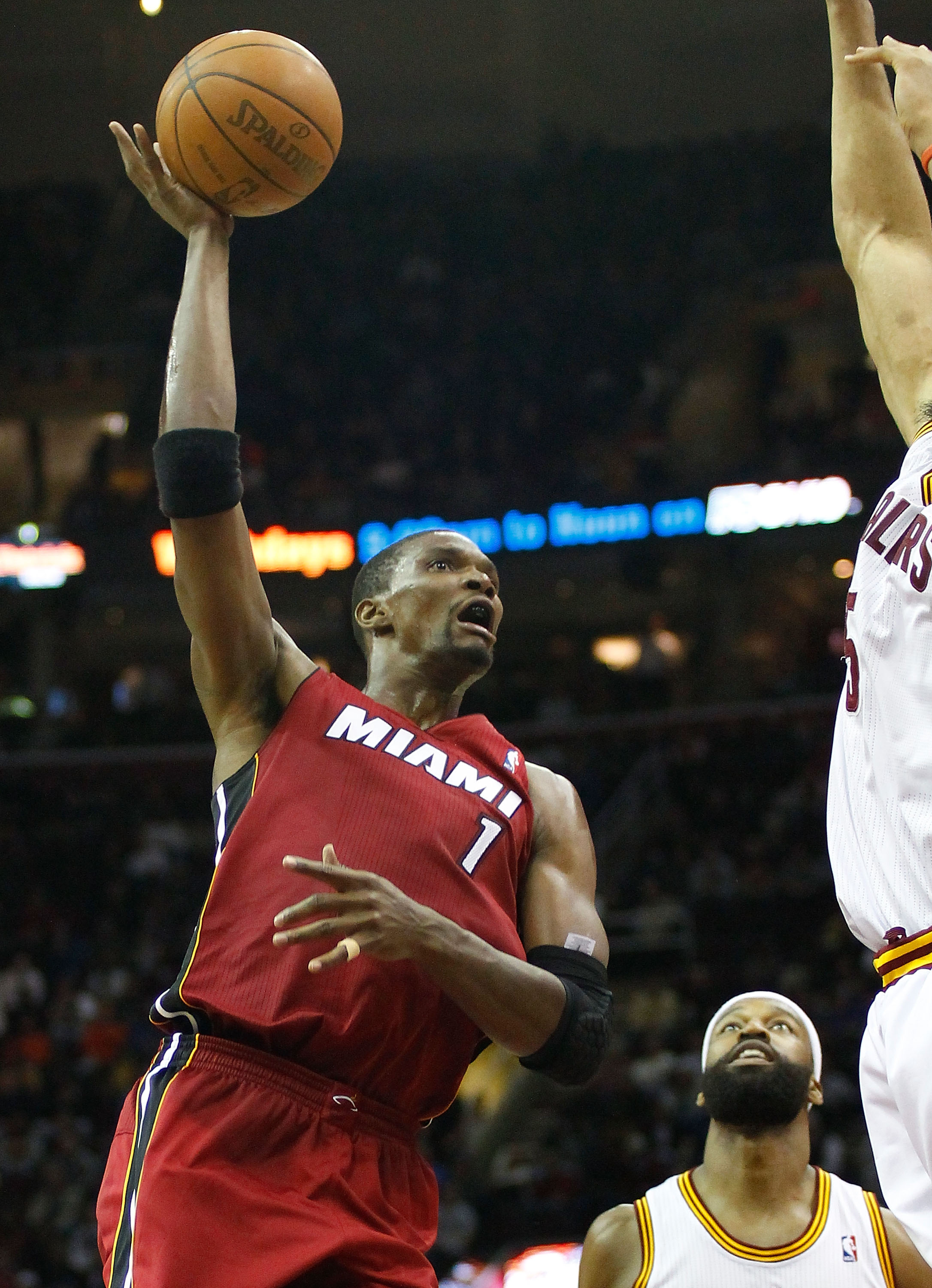 CLEVELAND - MARCH 29: Chris Bosh #1 of the Miami Heat attempts a shot during the game against the Cleveland Cavaliers on March 29, 2011 at Quicken Loans Arena in Cleveland, Ohio. NOTE TO USER: User expressly acknowledges and agrees that, by downloading an