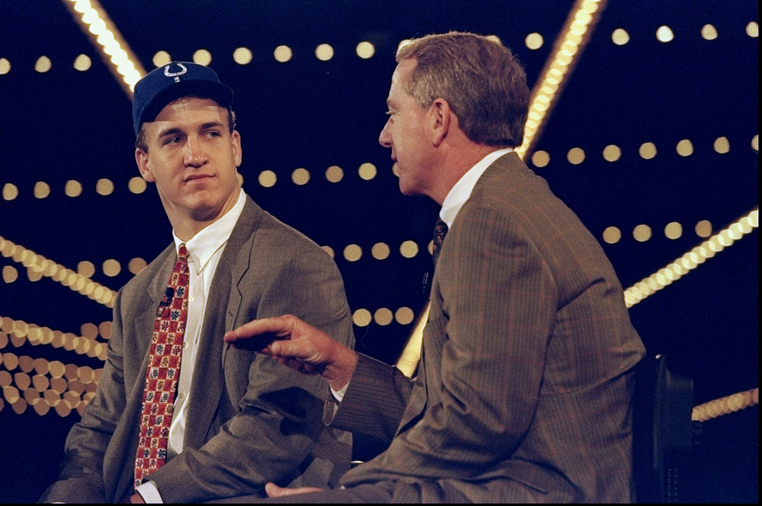 18 Apr 1998:  Quarterback Peyton Manning talks to his father Archie Manning during the NFL draft at Madison Square Garden in New York City, New York. Mandatory Credit: Jamie Squire  /Allsport