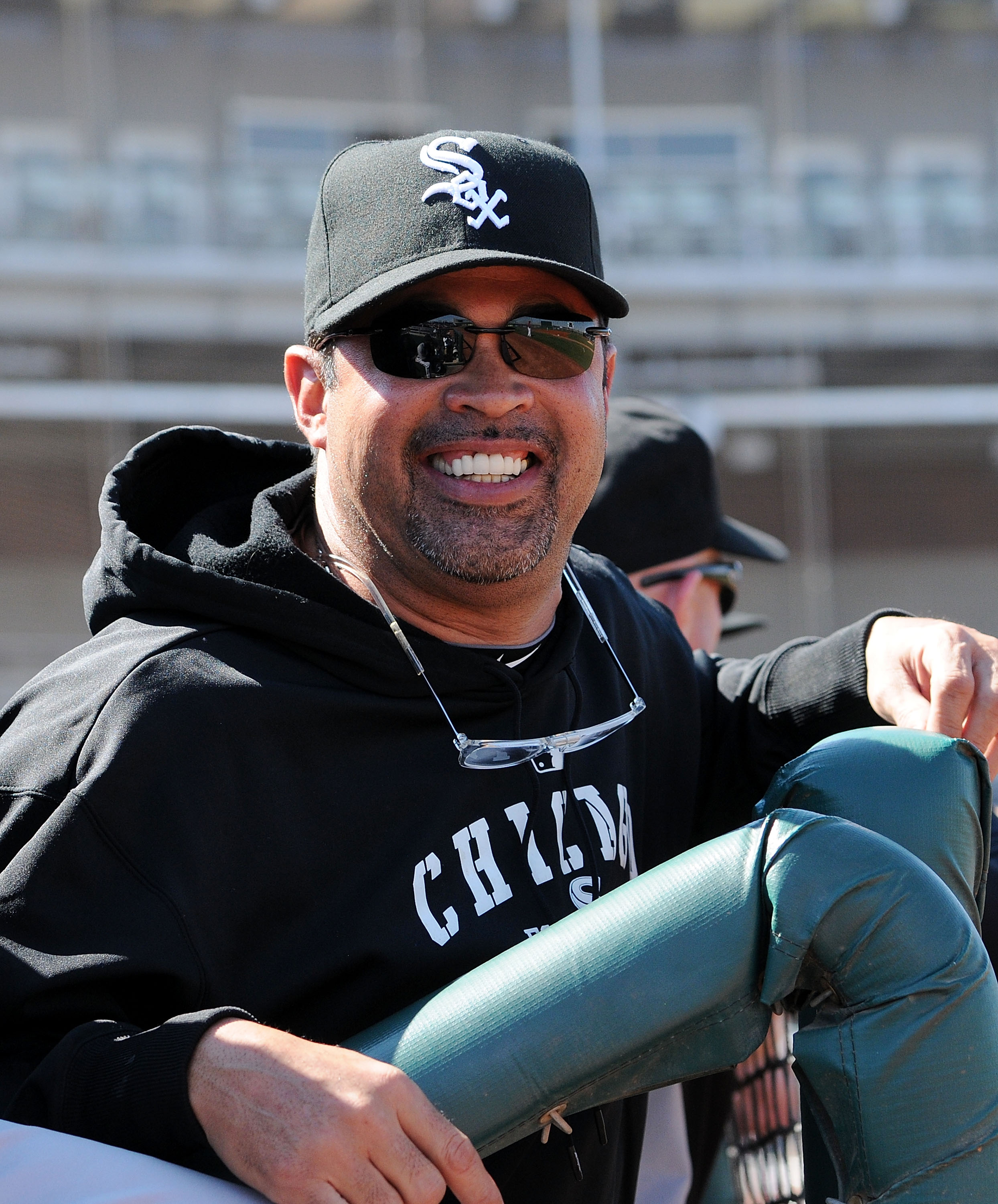 GOODYEAR, AZ - MARCH 02:  Manager Ozzie Guillen of the Chicago White Sox smiles while watching warm-ups prior to a game against the Cincinnati Reds at Goodyear Ballpark on March 2, 2011 in Goodyear, Arizona.  (Photo by Norm Hall/Getty Images)