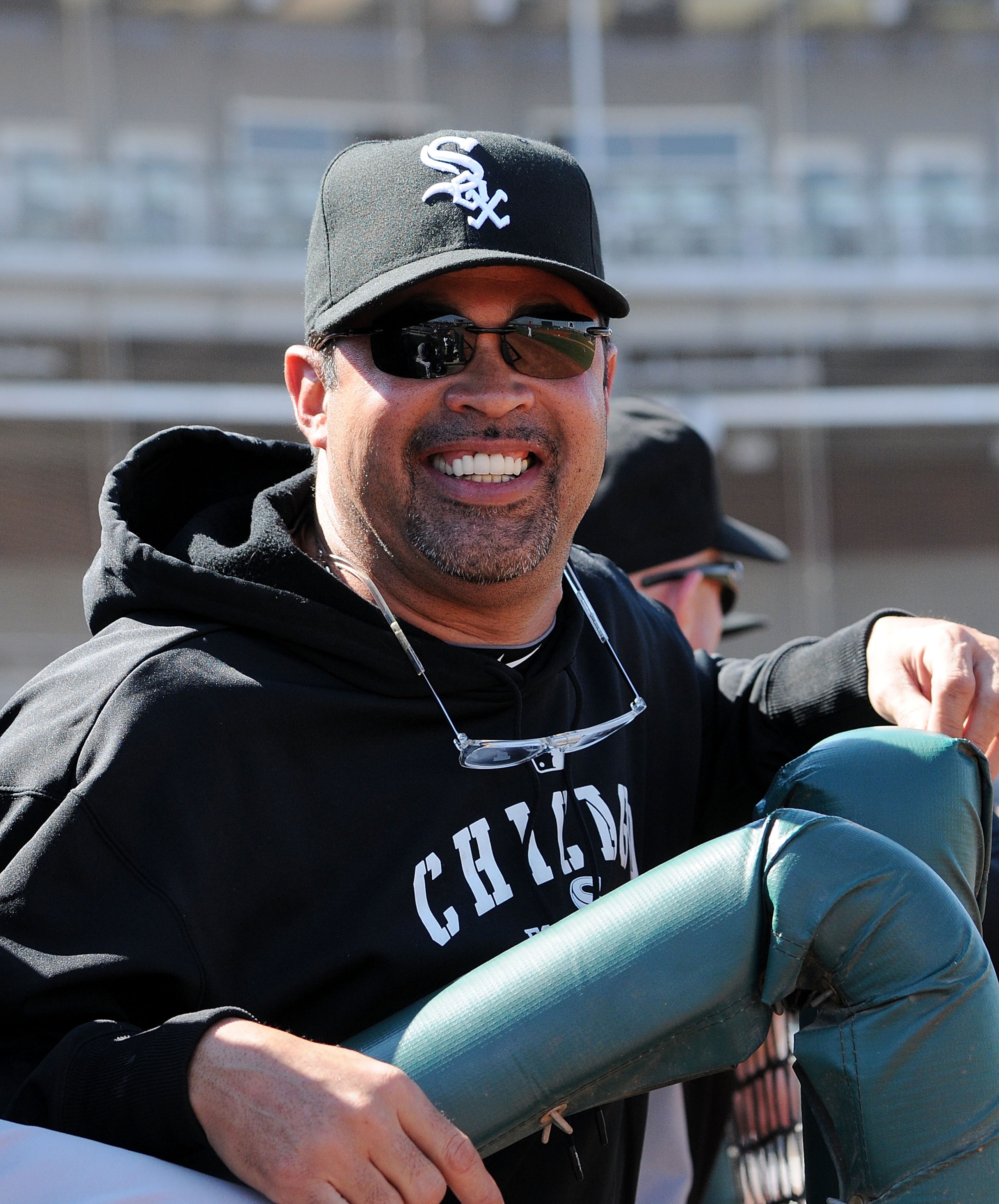 GOODYEAR, AZ - MARCH 02:  Manager Ozzie Guillen of the Chicago White Sox smiles while watching warm-ups prior to a game against the Cincinnati Reds at Goodyear Ballpark on March 2, 2011 in Goodyear, Arizona.  (Photo by Norm Hall/Getty Images)