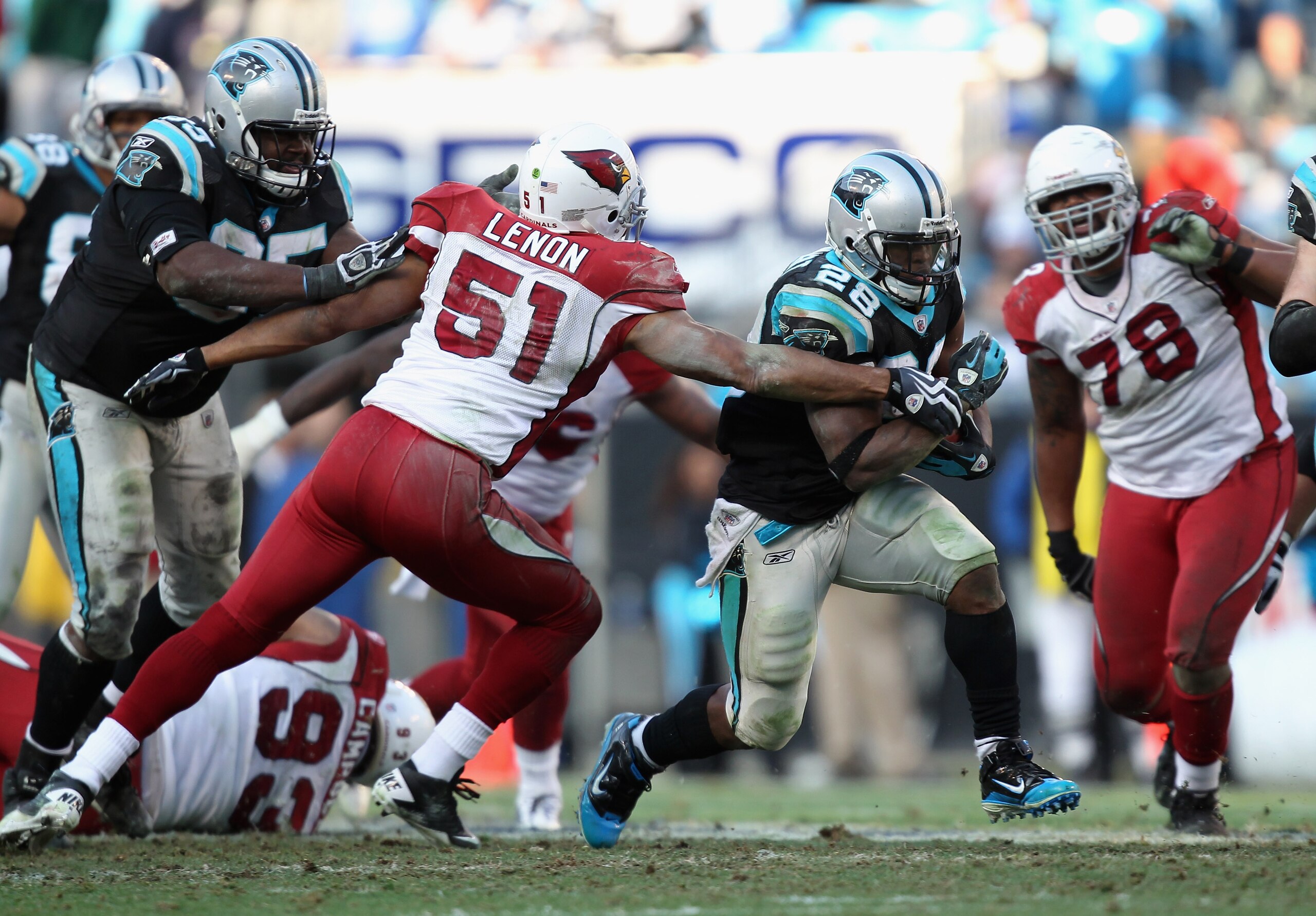 CHARLOTTE, NC - DECEMBER 19:  Jonathan Stewart #28 of the Carolina Panthers runs away from Paris Lenon #51 of the Arizona Cardinals during their game at Bank of America Stadium on December 19, 2010 in Charlotte, North Carolina.  (Photo by Streeter Lecka/G