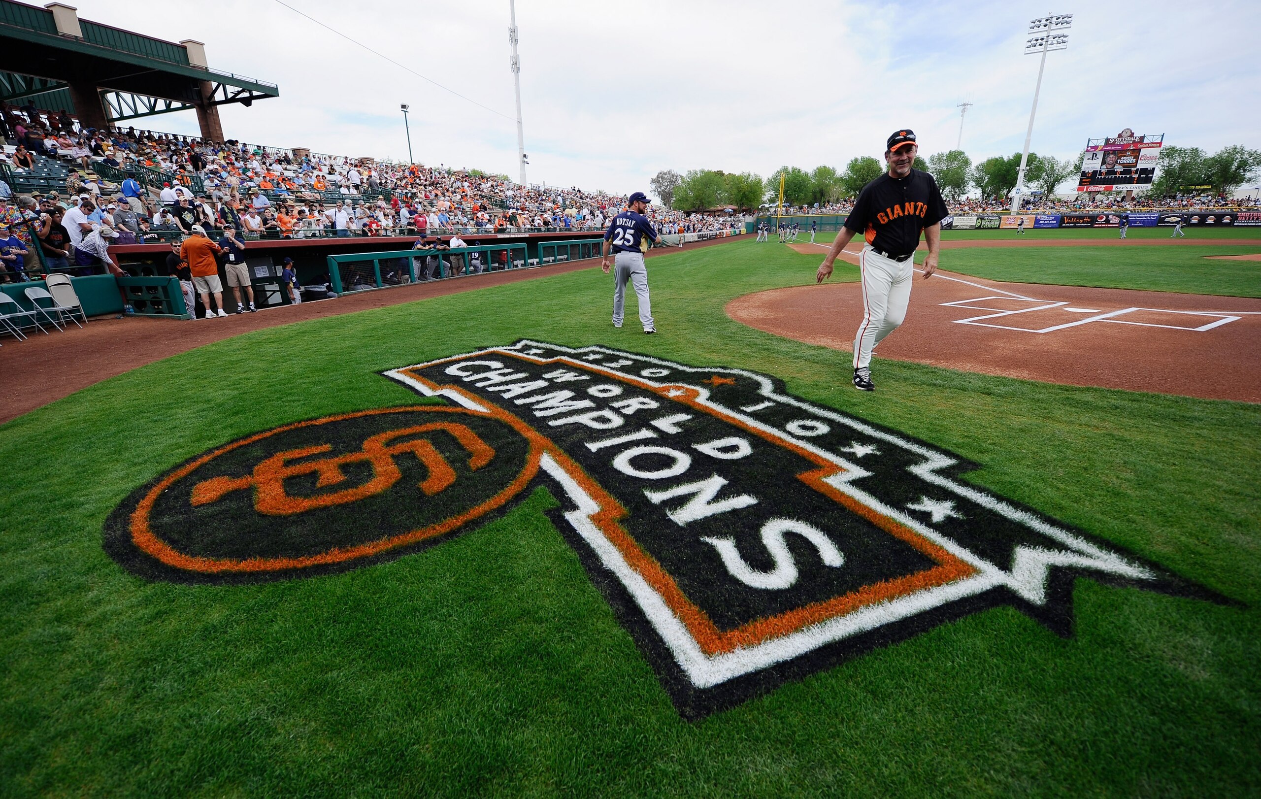 SCOTTSDALE, AZ - MARCH 14:  Manager Bruce Botchy #15 of the San Francisco Giants talks with Mark Kotsay #25 of the Milwaukee Brewers during the spring training baseball game against tat Scottsdale Stadium on March 14, 2011 in Scottsdale, Arizona.  (Photo