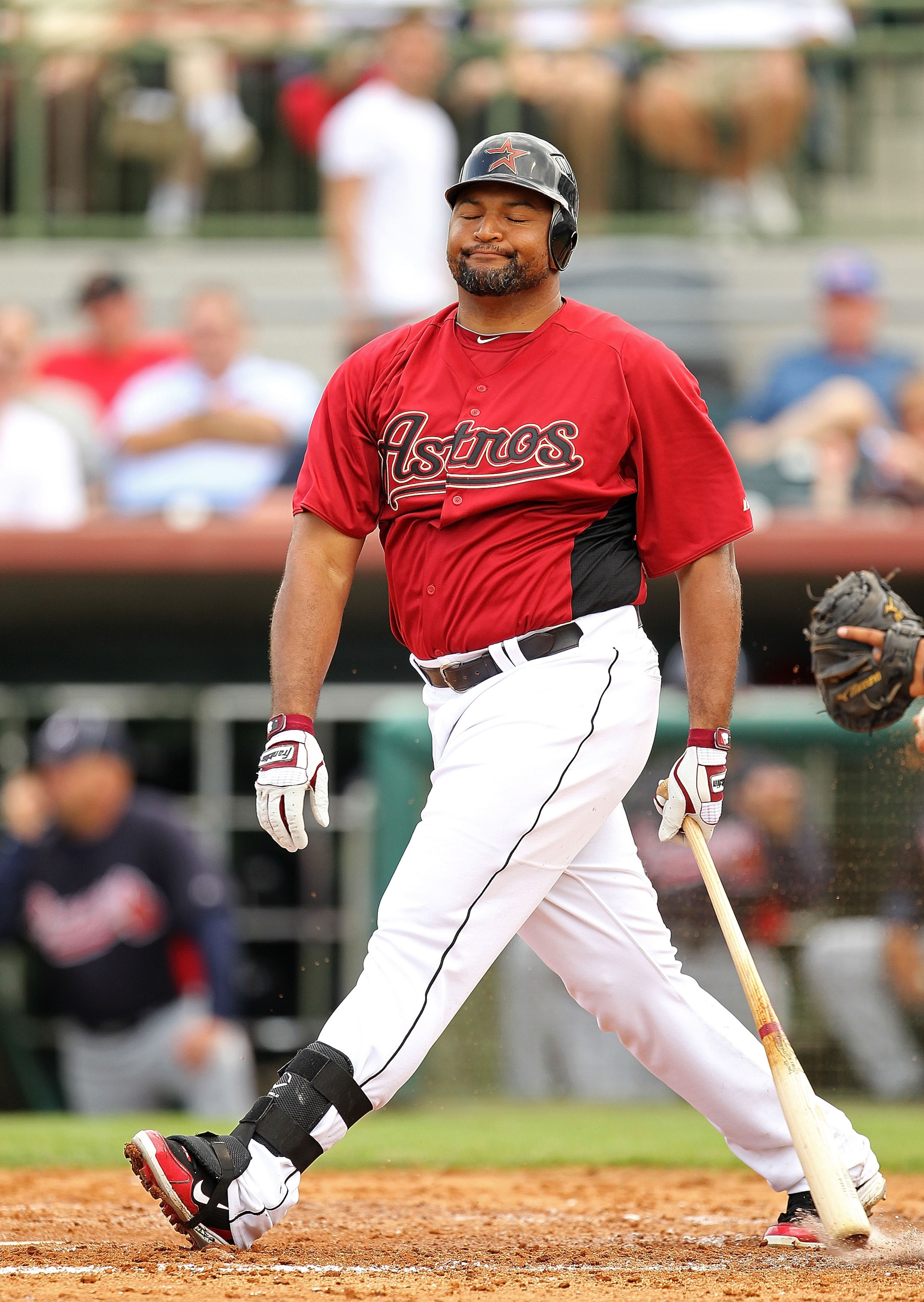 KISSIMMEE, FL - MARCH 01: Carlos Lee #45 of the Houston Astros reacts after a bad swing during a Spring Training game against the Atlanta Braves at Osceola County Stadium on March 1, 2011 in Kissimmee, Florida.  (Photo by Mike Ehrmann/Getty Images)