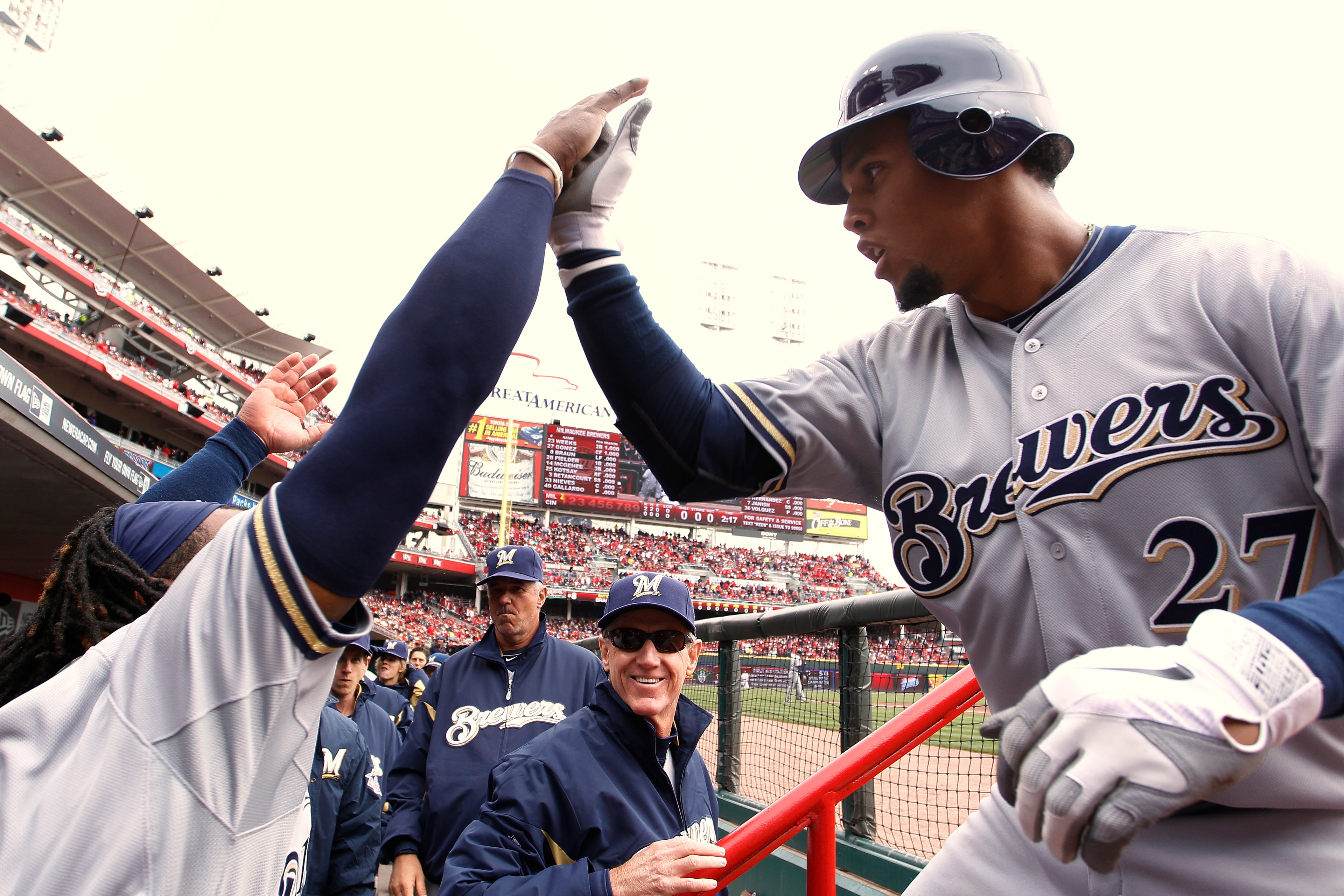 CINCINNATI, OH - MARCH 31: Carlos Gomez #27 of the Milwaukee Brewers celebrates with teammates after a first inning home run during the opening day game against the Cincinnati Reds at Great American Ballpark on March 31, 2011 in Cincinnati, Ohio. (Photo b CINCINNATI, OH - MARCH 31: Carlos Gomez #27 of the Milwaukee Brewers celebrates with teammates after a first inning home run during the opening day game against the Cincinnati Reds at Great American Ballpark on March 31, 2011 in Cincinnati, Ohio. (Photo b