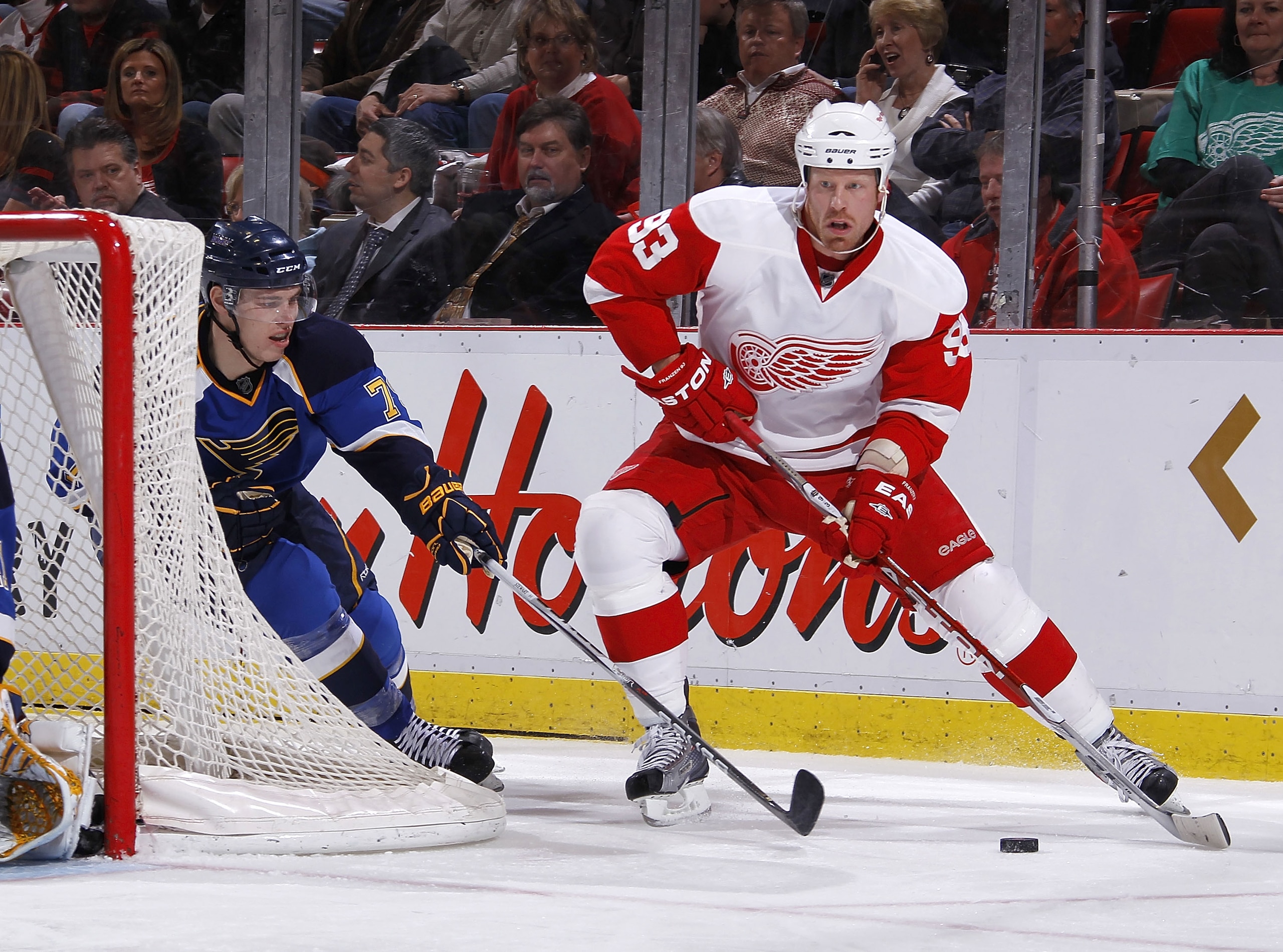 DETROIT, MI - MARCH 30: Johan Franzen #93 of the Detroit Red Wings tries to keep the puck from the stick of Adam Cracknell #79 of the St. Louis Blues at Joe Louis Arena on March 30, 2011 in Detroit, Michigan.  (Photo by Gregory Shamus/Getty Images)
