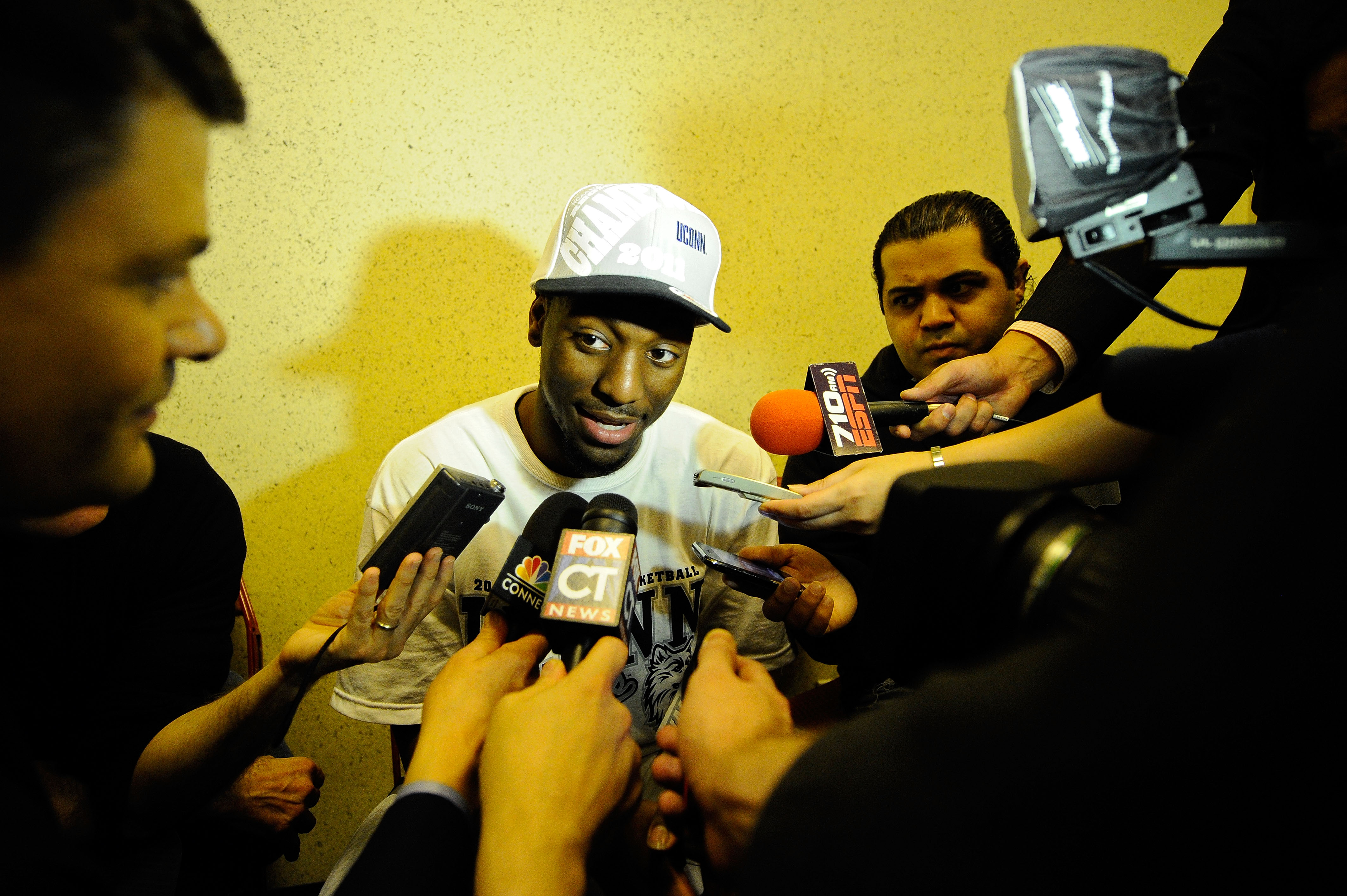 ANAHEIM, CA - MARCH 26:  Kemba Walker #15 of the Connecticut Huskies talks to the media in the locker room after defeating the Arizona Wildcats during the west regional final of the 2011 NCAA men's basketball tournament at the Honda Center on March 26, 20