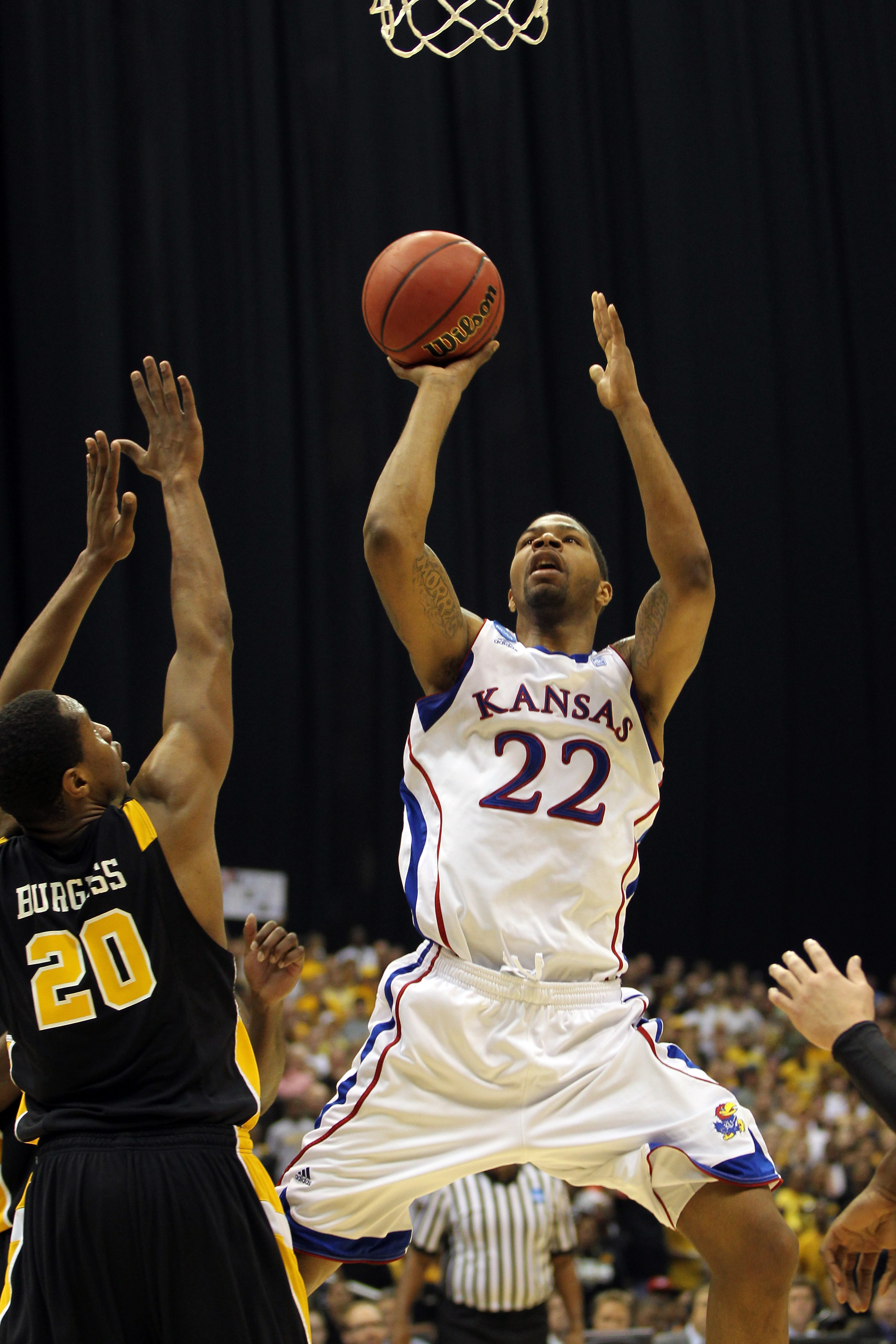SAN ANTONIO, TX - MARCH 27:  Marcus Morris #22 of the Kansas Jayhawks puts up a shot against Bradford Burgess #20 of the Virginia Commonwealth Rams during the southwest regional final of the 2011 NCAA men's basketball tournament at the Alamodome on March