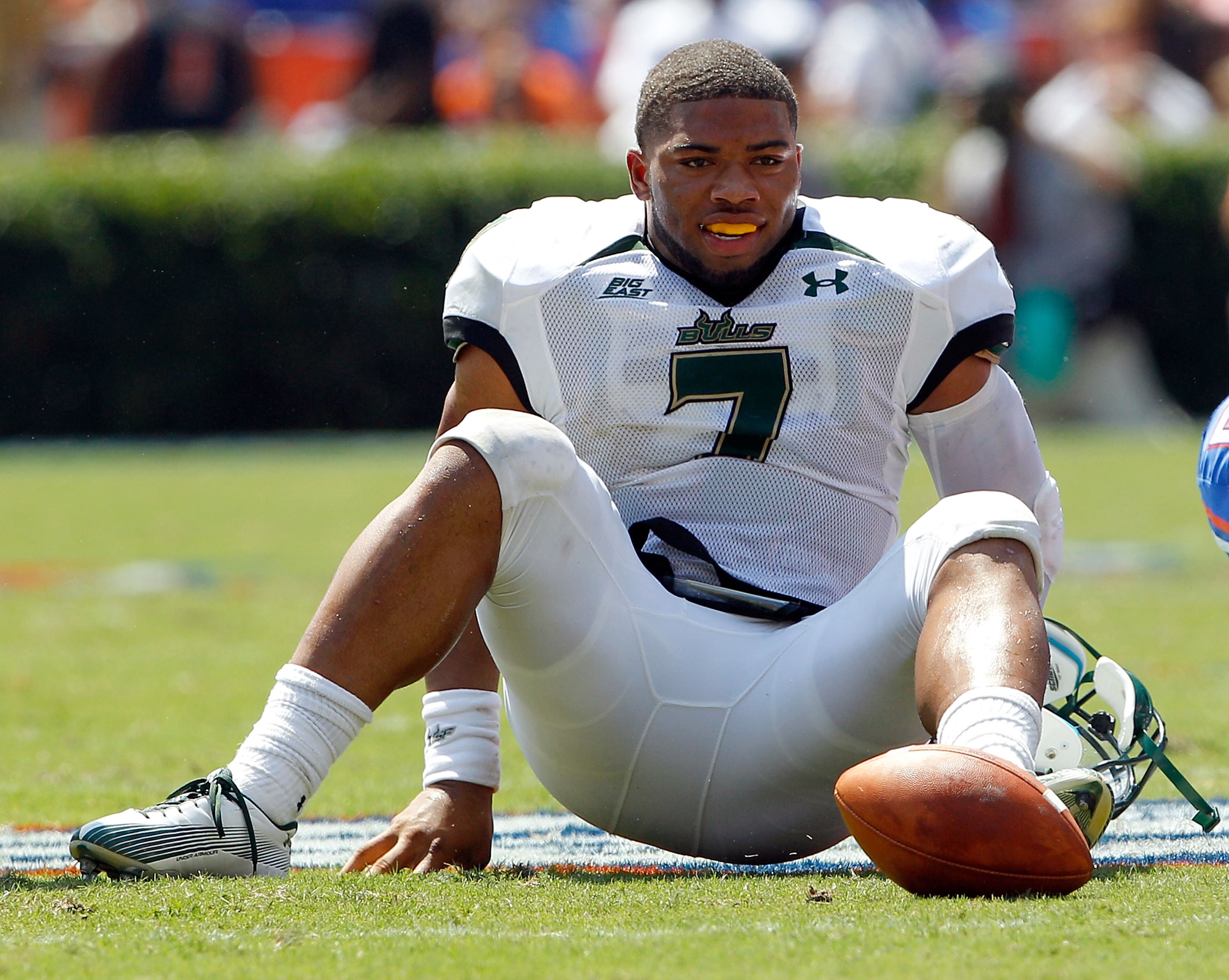 GAINESVILLE, FL - SEPTEMBER 11: Quarterback B.J. Daniels #7 of the South Florida Bulls loses his helmet after being tackled during a game against the Florida Gators at Ben Hill Griffin Stadium on September 11, 2010 in Gainesville, Florida. (Photo by Sam GAINESVILLE, FL - SEPTEMBER 11: Quarterback B.J. Daniels #7 of the South Florida Bulls loses his helmet after being tackled during a game against the Florida Gators at Ben Hill Griffin Stadium on September 11, 2010 in Gainesville, Florida. (Photo by Sam