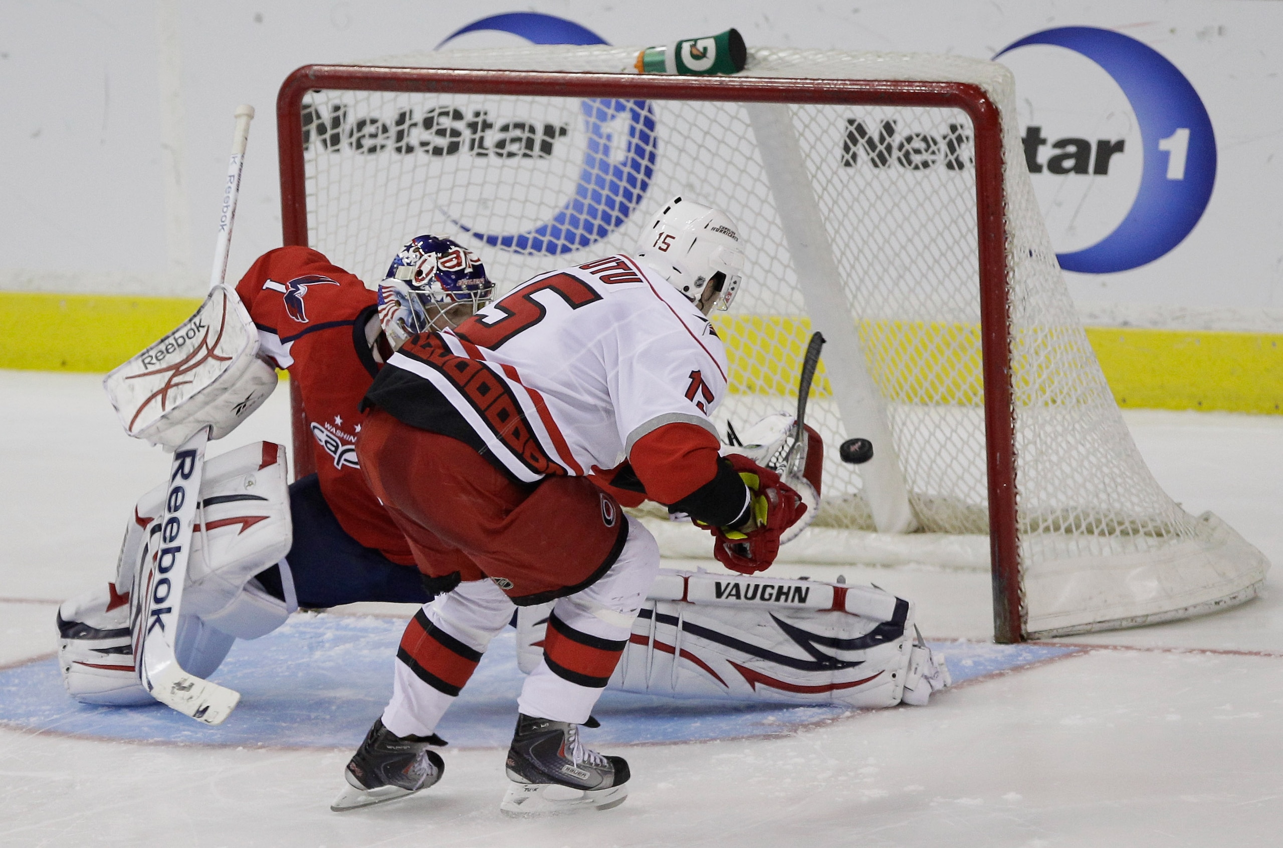 WASHINGTON, DC - MARCH 29:  Tuomo Ruutu #15 of the Carolina Hurricanes scores the game clinching goal on goalie Semyon Varlamov #1 of the Washington Capitals during a shootout at the Verizon Center on March 29, 2011 in Washington, DC. (Photo by Rob Carr/G