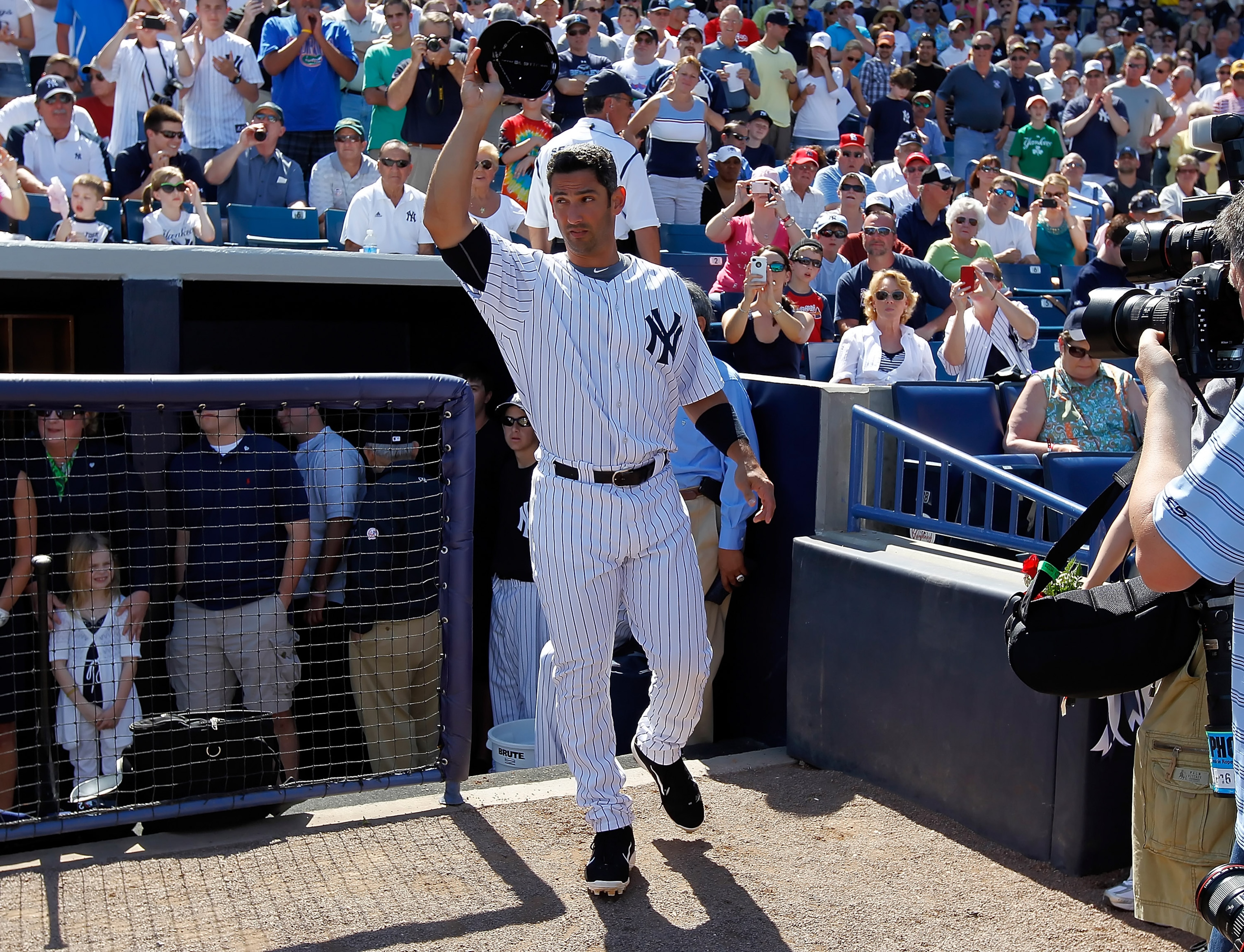 TAMPA, FL - FEBRUARY 26:  Designated hitter Jorge Posada #20 of the New York Yankees tips his hat to the crowd as he is announced just prior to the start of the Grapefruit League Spring Training Game against the Philadelphia Phillies at George M. Steinbre