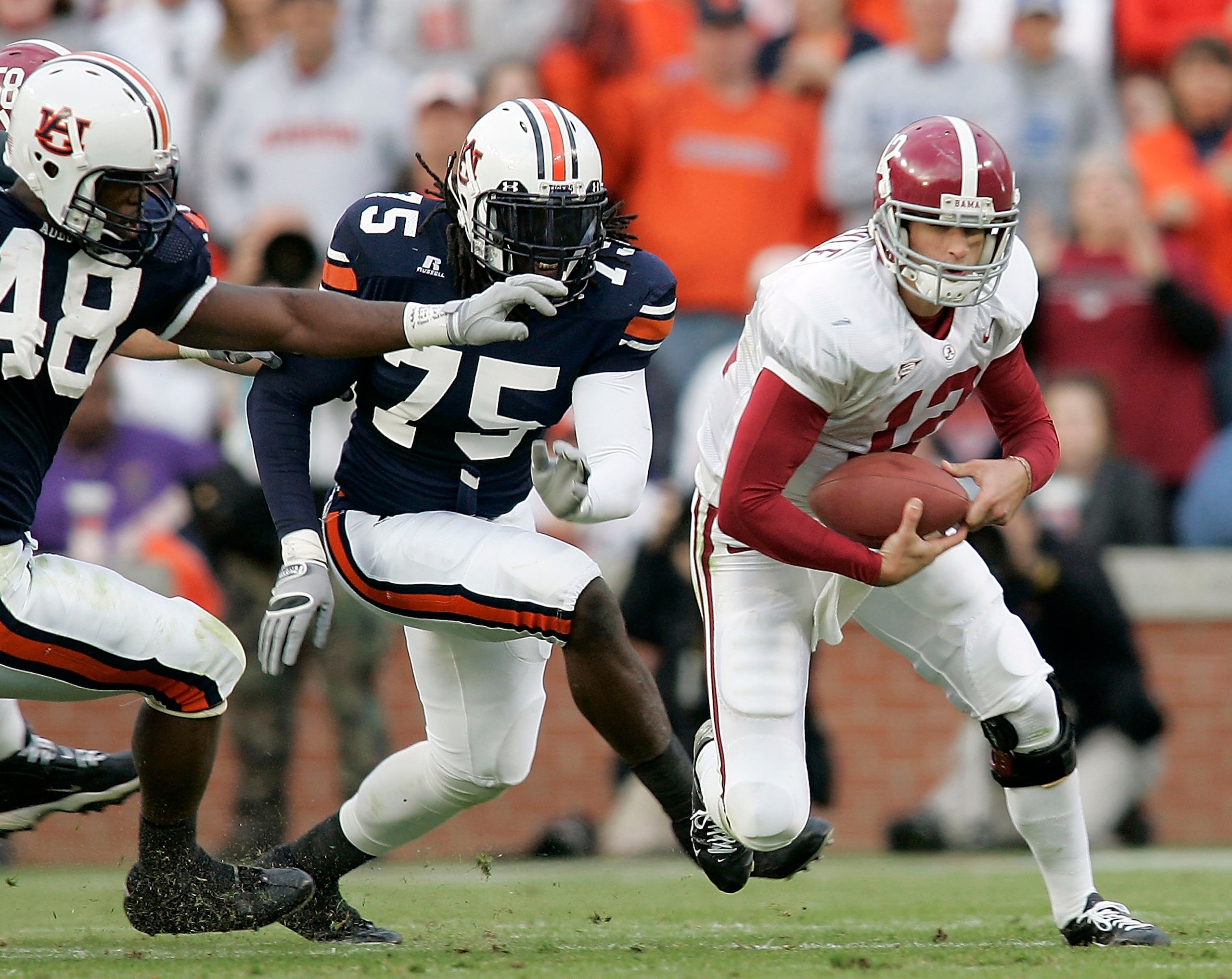 AUBURN, AL - NOVEMBER 19: Quarterback Brodie Croyle #12 of the University of Alabama is chased by Marquies Gunn #48 and Stanley McClover #75 of Auburn University on November 19, 2005 at Jordan-Hare Stadium in Auburn, Alabama. (Photo by Chris Graythen/G AUBURN, AL - NOVEMBER 19: Quarterback Brodie Croyle #12 of the University of Alabama is chased by Marquies Gunn #48 and Stanley McClover #75 of Auburn University on November 19, 2005 at Jordan-Hare Stadium in Auburn, Alabama. (Photo by Chris Graythen/G