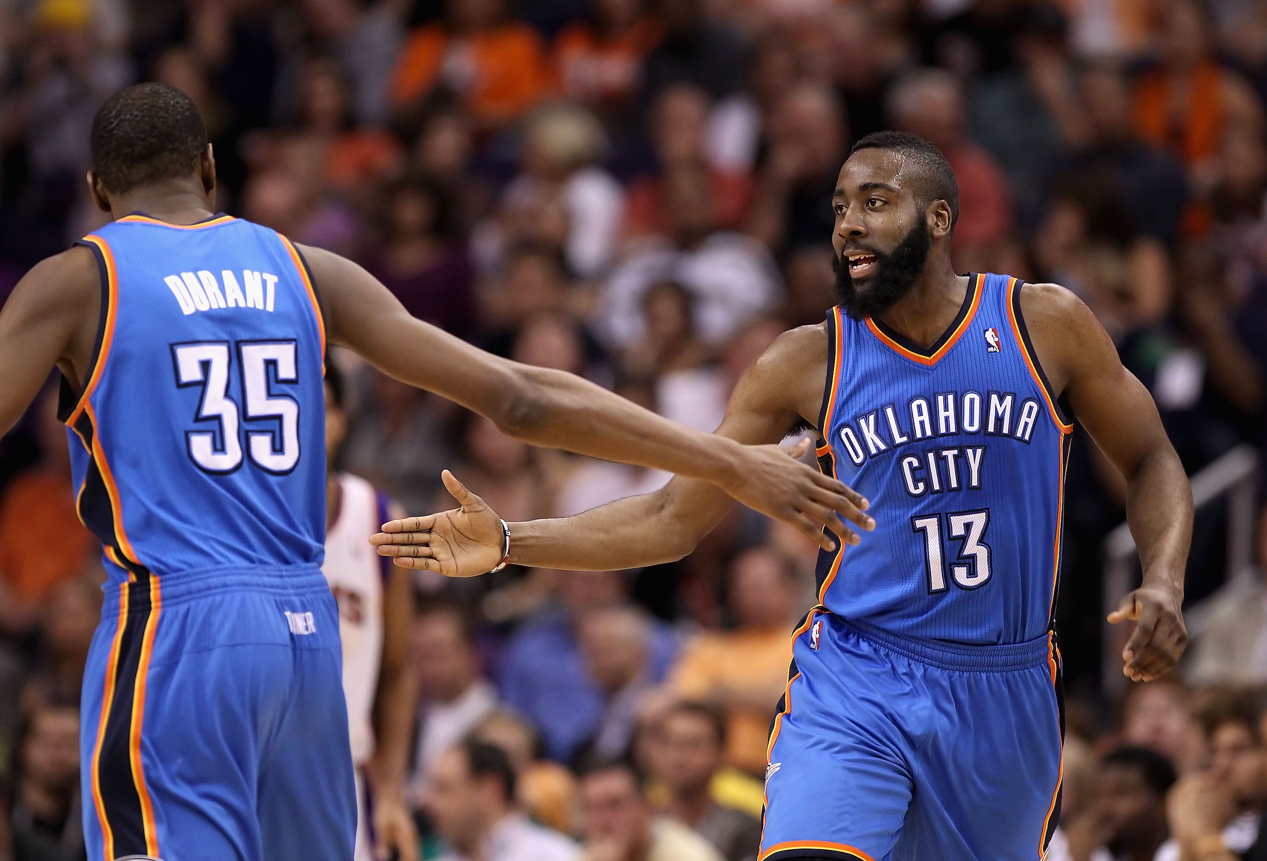 PHOENIX, AZ - MARCH 30:  James Harden #13 of the Oklahoma City Thunder high fives teamate Kevin Durant #35 after scoring against the Phoenix Suns during the NBA game at US Airways Center on March 30, 2011 in Phoenix, Arizona. The Thunder defeated the Suns