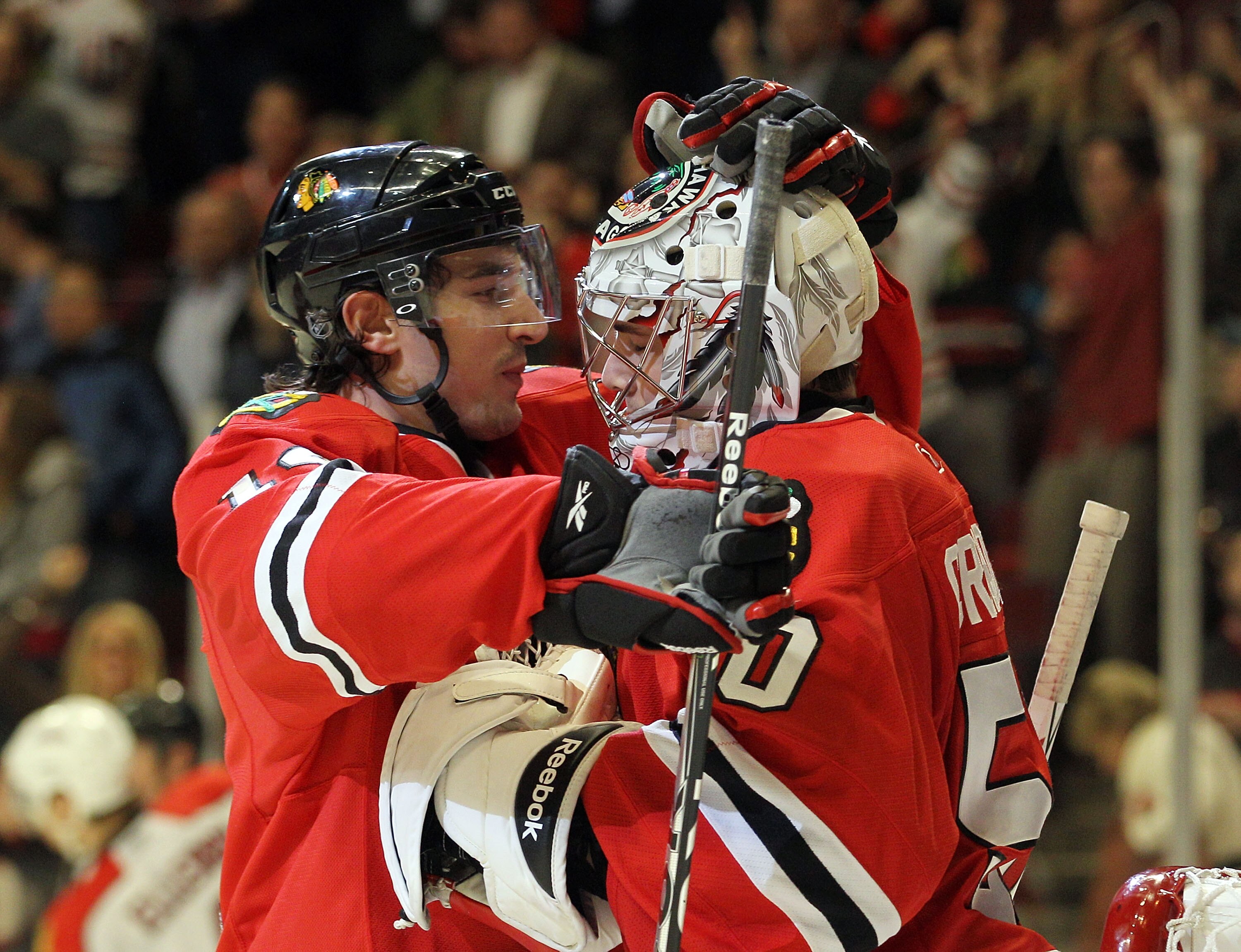 CHICAGO, IL - MARCH 23: Chris Campoli #14 and Corey Crawford #50 of the Chicago Blackhawks celebrate their win over the Florida Panthers at the United Center on March 23, 2011 in Chicago, Illinois. The Blackhawks defeated the Panthers 4-0.  (Photo by Bruc