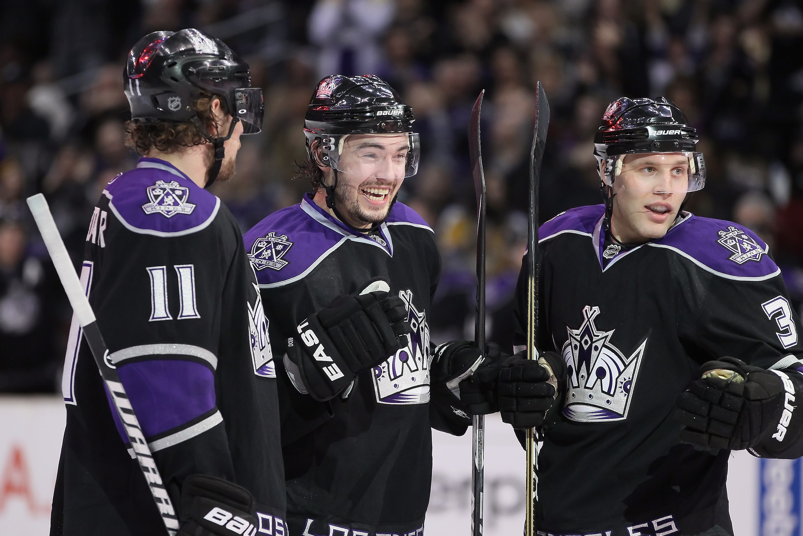 LOS ANGELES, CA - FEBRUARY 26:  (L-R) Anze Kopitar #11, Drew Doughty #8 and Jack Johnson #3 of the Los Angeles Kings celebrate Doughty's second period goal against the Colorado Avalanche at Staples Center on February 26, 2011 in Los Angeles, California. T