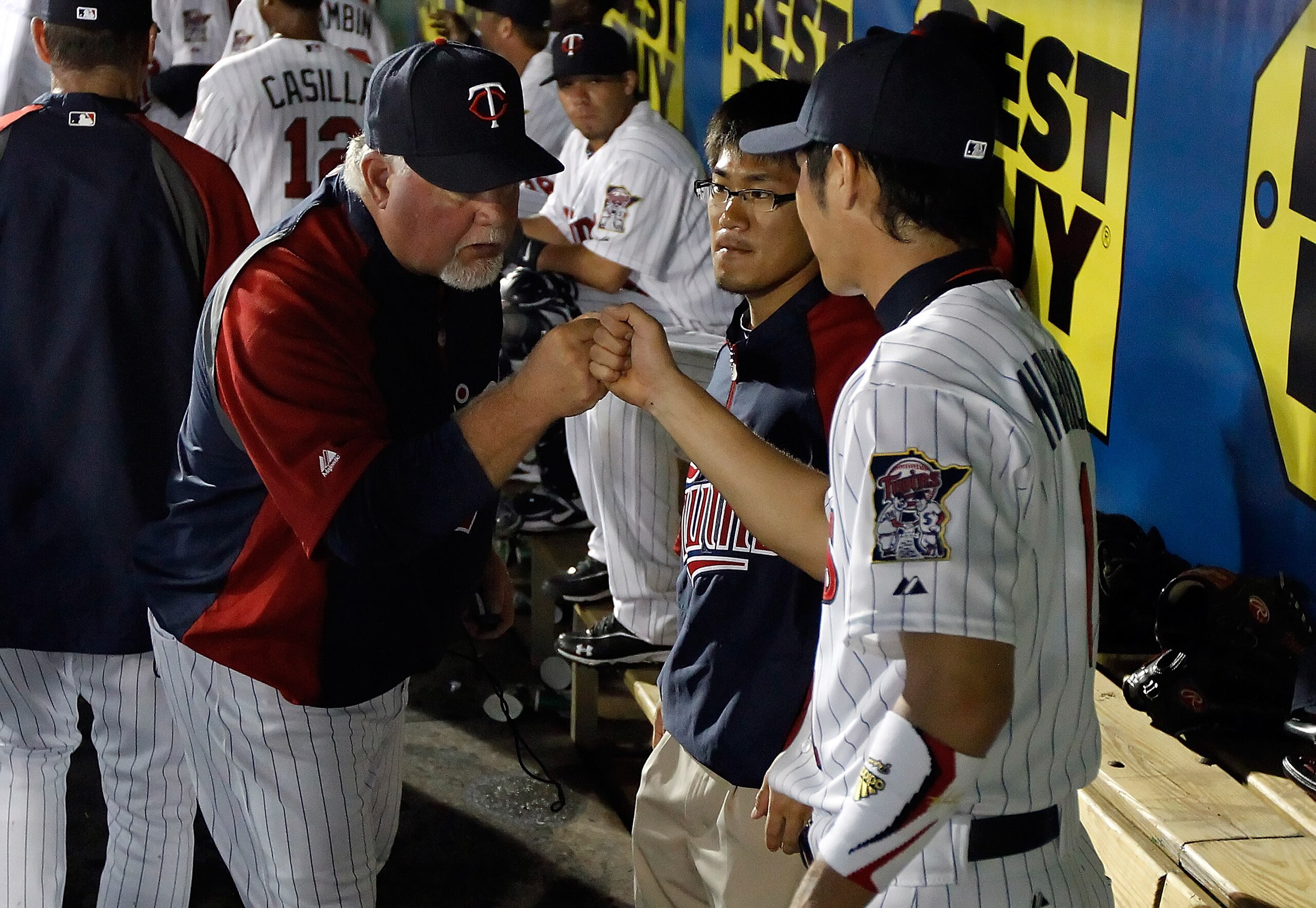 FORT MYERS, FL - FEBRUARY 27:  Manager Ron Gardenhire #35 congratulates infielder Tsuyoshi Nishioka #1 of the Minnesota Twins after making a great play against the Boston Red Sox during a Grapefruit League Spring Training Game at Hammond Stadium on Februa