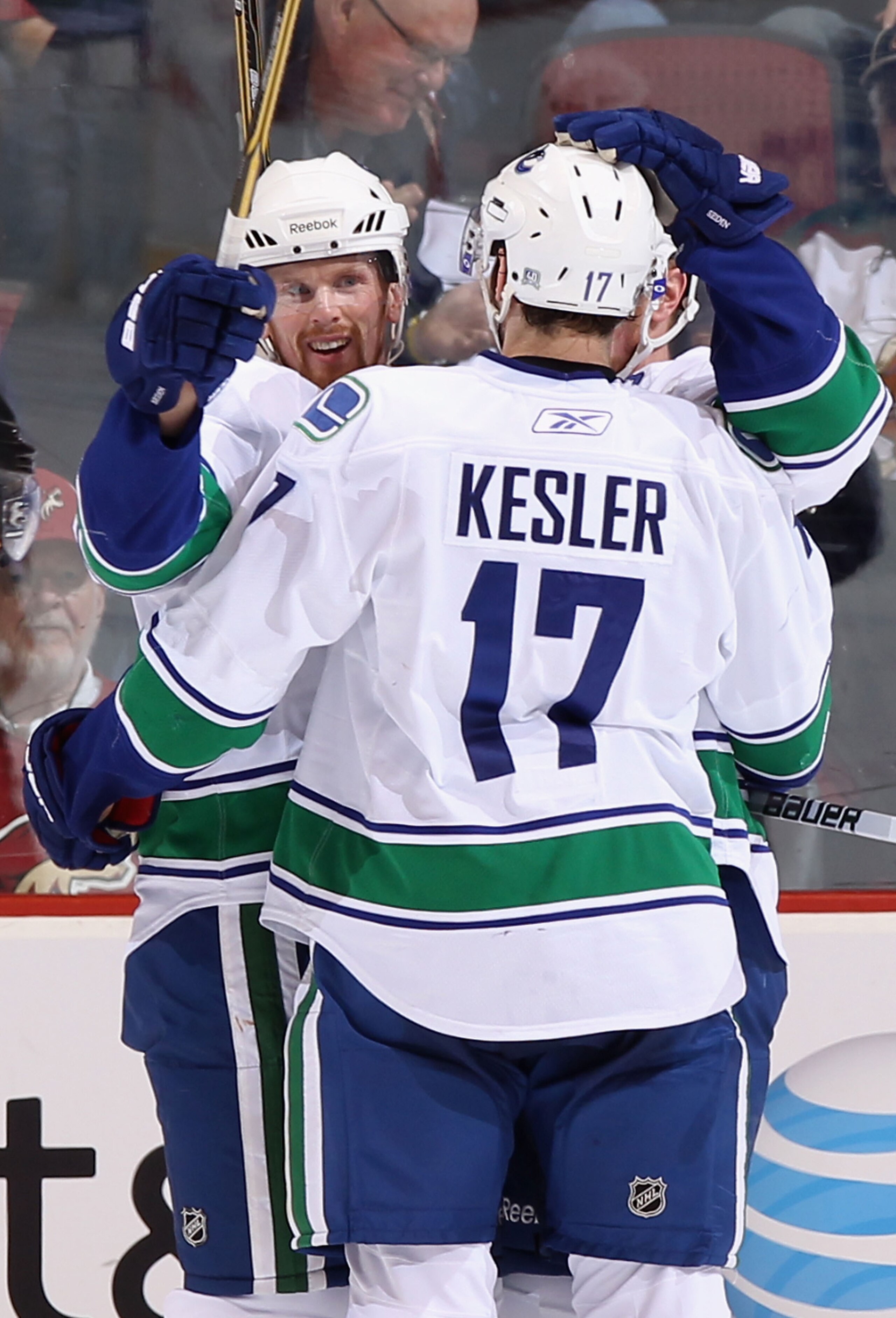GLENDALE, AZ - MARCH 08:  (L-R) Daniel Sedin #22, Ryan Kesler #17 and Henrik Sedin #33 of the Vancouver Canucks celebrate after Henrik Sedin scored a second period goal against the Phoenix Coyotes during the NHL game at Jobing.com Arena on March 8, 2011 i