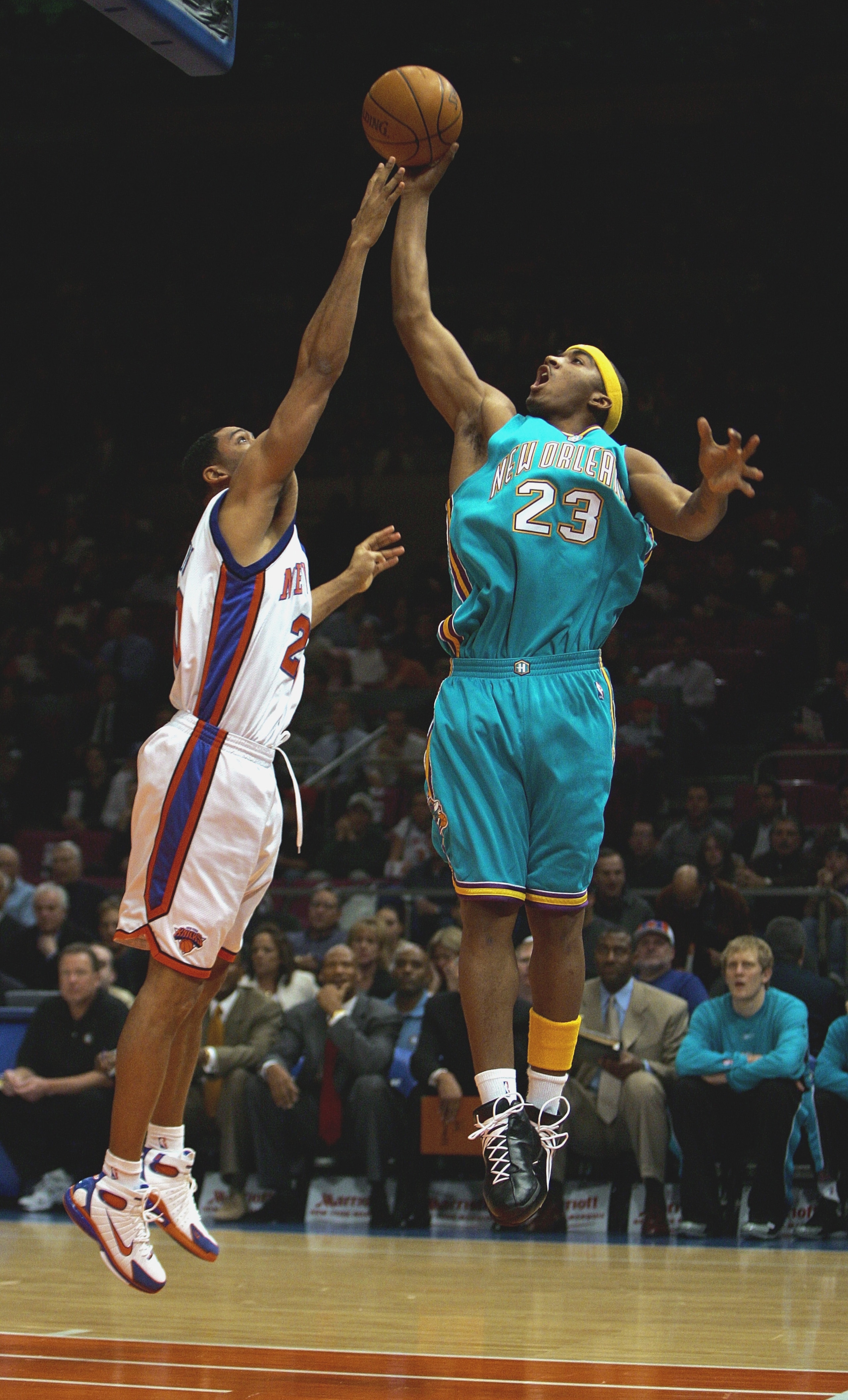 NEW YORK - JANUARY 11:  J.R. Smith #23 of the New Orleans Hornets puts up a shot against Allan Houston #20 of the New York Knicks on January 11, 2005 at Madison Square Garden in New York City. (Photo by Ezra Shaw/Getty Images)