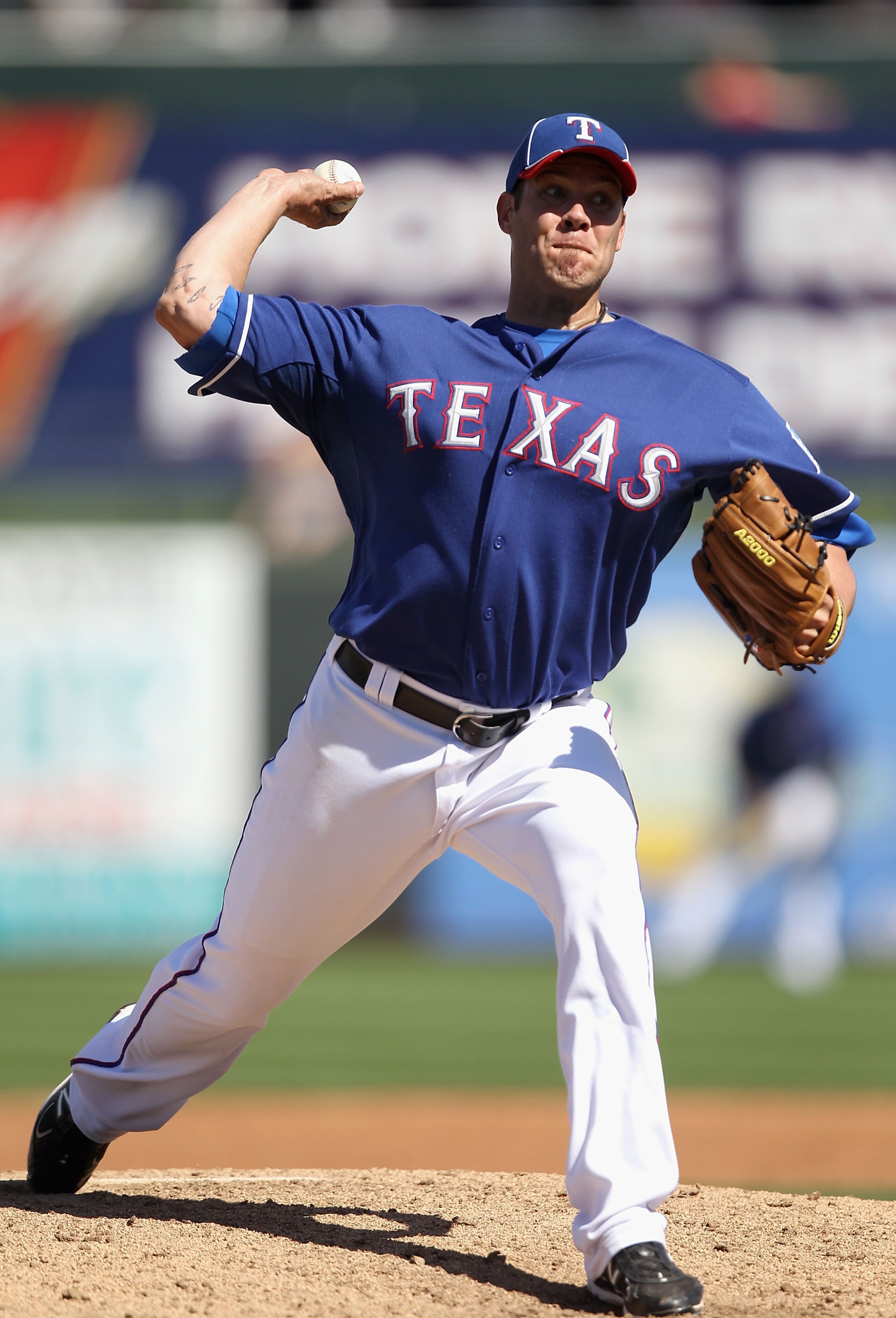 SURPRISE, AZ - MARCH 11:  Starting pitcher Colby Lewis #48 of the Texas Rangers pitches against the Cincinnati Reds during the spring training game at Surprise Stadium on March 11, 2011 in Surprise, Arizona.  (Photo by Christian Petersen/Getty Images)