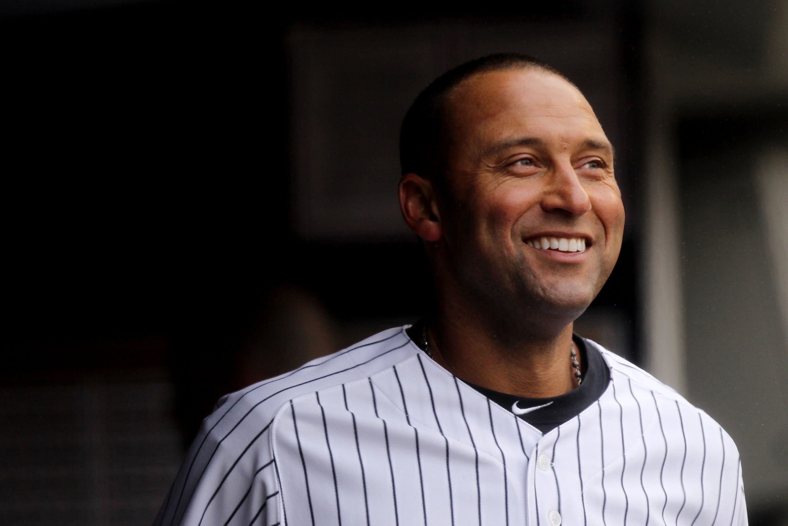 NEW YORK, NY - MARCH 31:  Derek Jeter #2 of the New York Yankees smiles as he looks on from the dugout during the game against the Detroit Tigers on Opening Day at Yankee Stadium on March 31, 2011 in New York City.  (Photo by Nick Laham/Getty Images)
