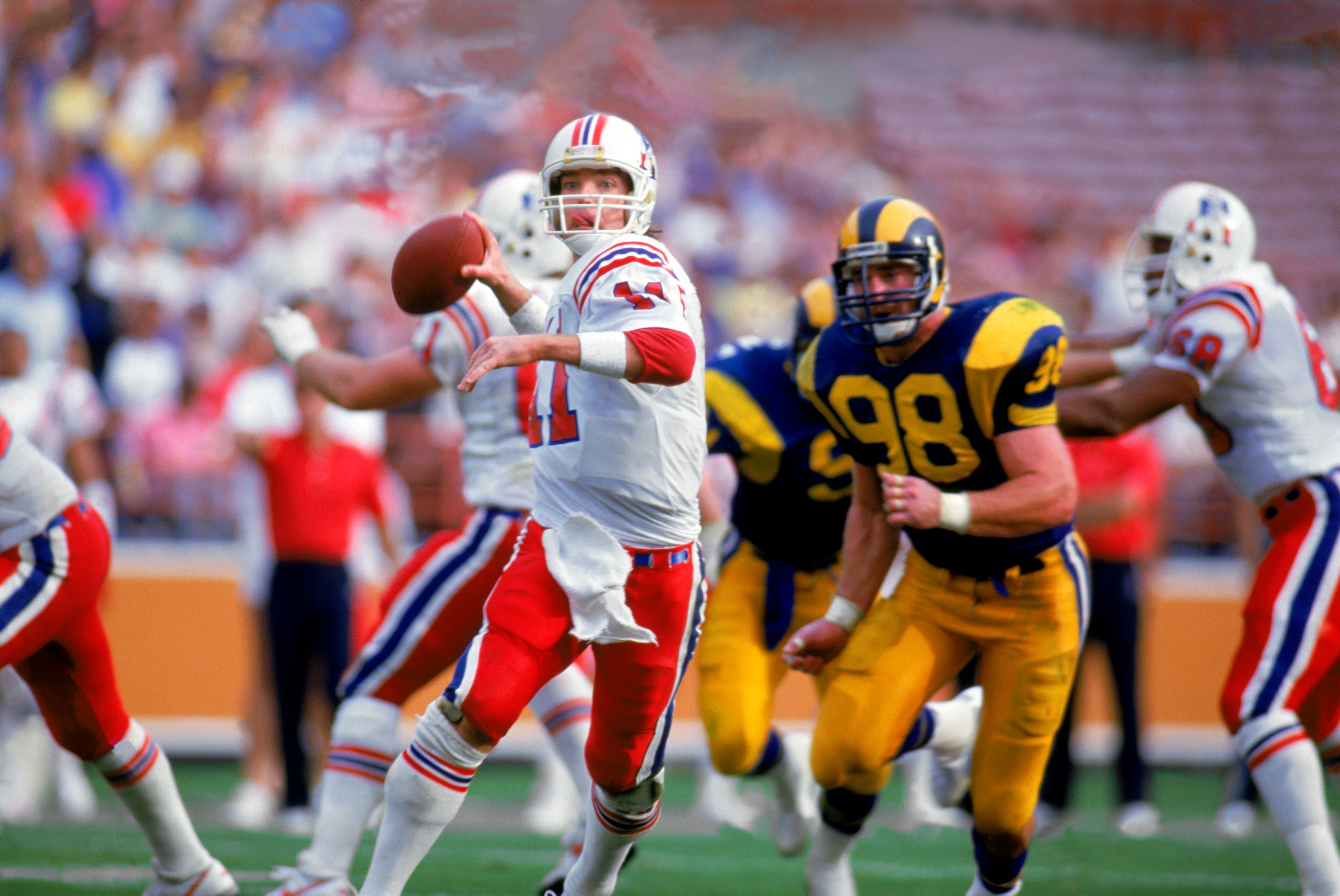 LOS ANGELES - 1986:  Quarterback Tony Eason #11 of the New England Patriots rolls out under pressure during a 1986 NFL game against the Los Angeles Rams at LA Memorial Coliseum in Los Angeles, California.  The Pats defeated the Rams 30-28.  (Photo by Tony