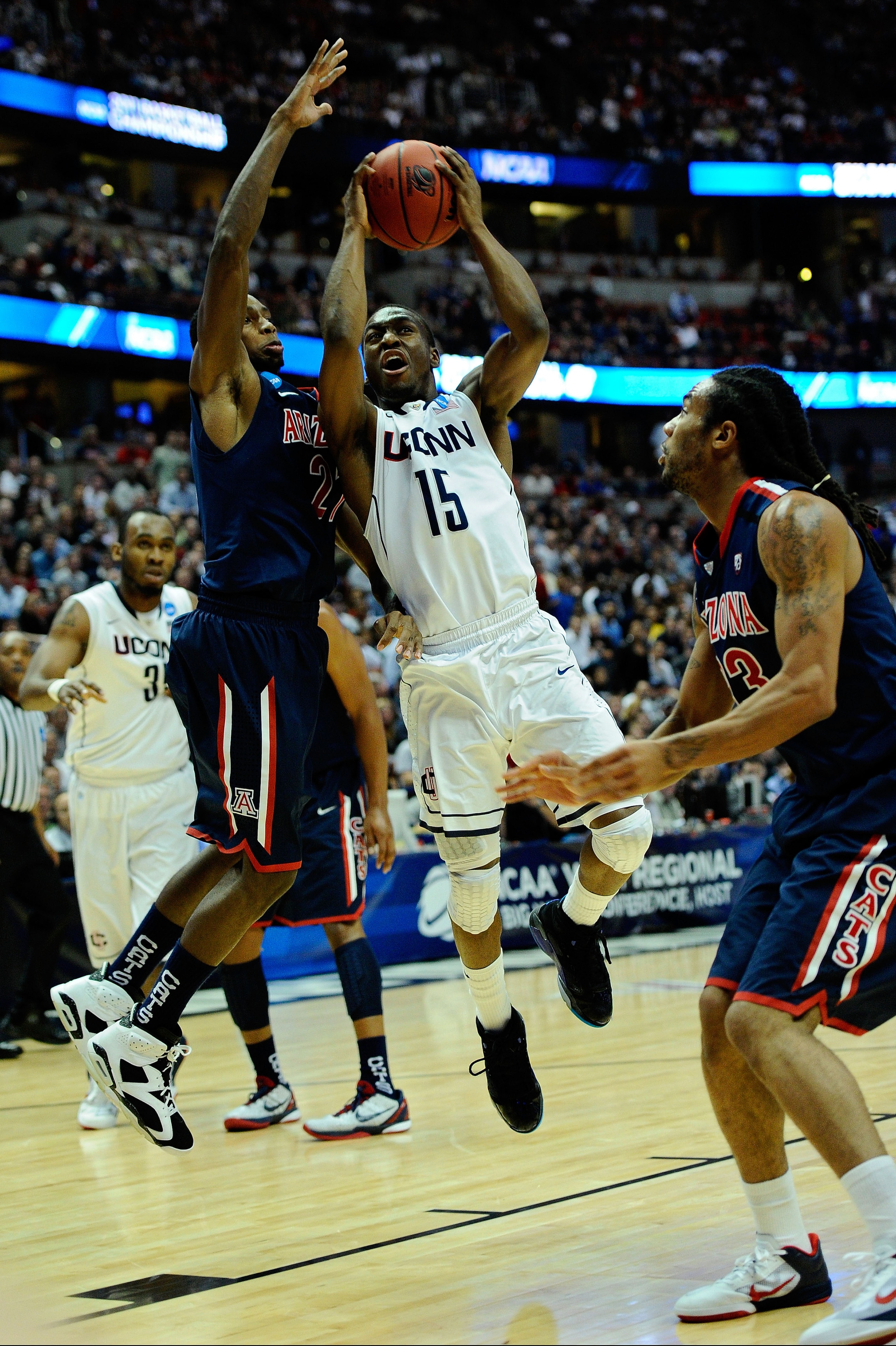ANAHEIM, CA - MARCH 26: Kemba Walker #15 of the Connecticut Huskies goes to the basket against Kyle Fogg #21 of the Arizona Wildcats during the west regional final of the 2011 NCAA men's basketball tournament at the Honda Center on March 26, 2011 in Anah ANAHEIM, CA - MARCH 26: Kemba Walker #15 of the Connecticut Huskies goes to the basket against Kyle Fogg #21 of the Arizona Wildcats during the west regional final of the 2011 NCAA men's basketball tournament at the Honda Center on March 26, 2011 in Anah