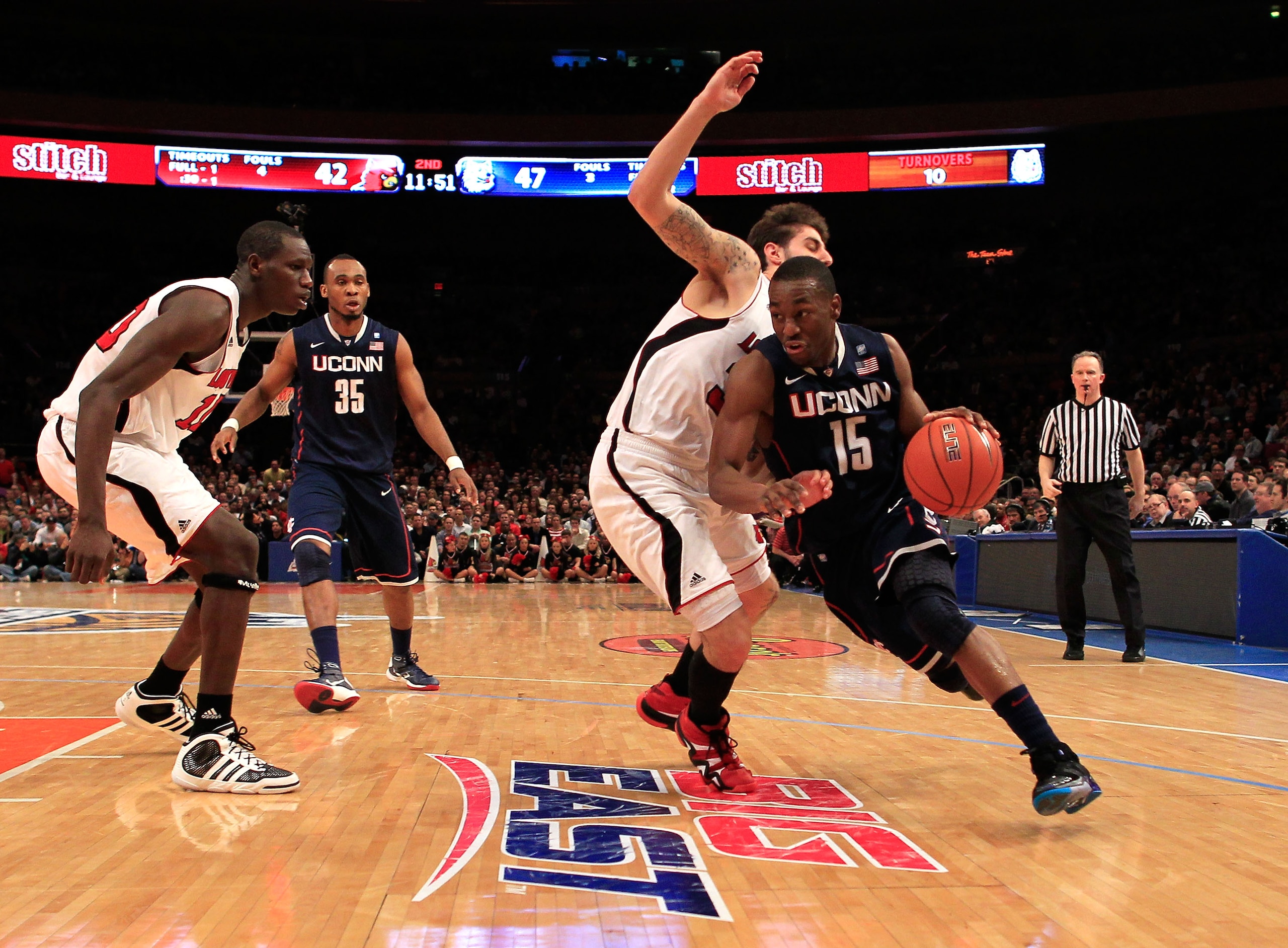 NEW YORK, NY - MARCH 12: Kemba Walker #15 of the Connecticut Huskies drives with the ball against Mike Marra #33 of the Louisville Cardinals during the championship of the 2011 Big East Men's Basketball Tournament presented by American Eagle Outfitters a NEW YORK, NY - MARCH 12: Kemba Walker #15 of the Connecticut Huskies drives with the ball against Mike Marra #33 of the Louisville Cardinals during the championship of the 2011 Big East Men's Basketball Tournament presented by American Eagle Outfitters a