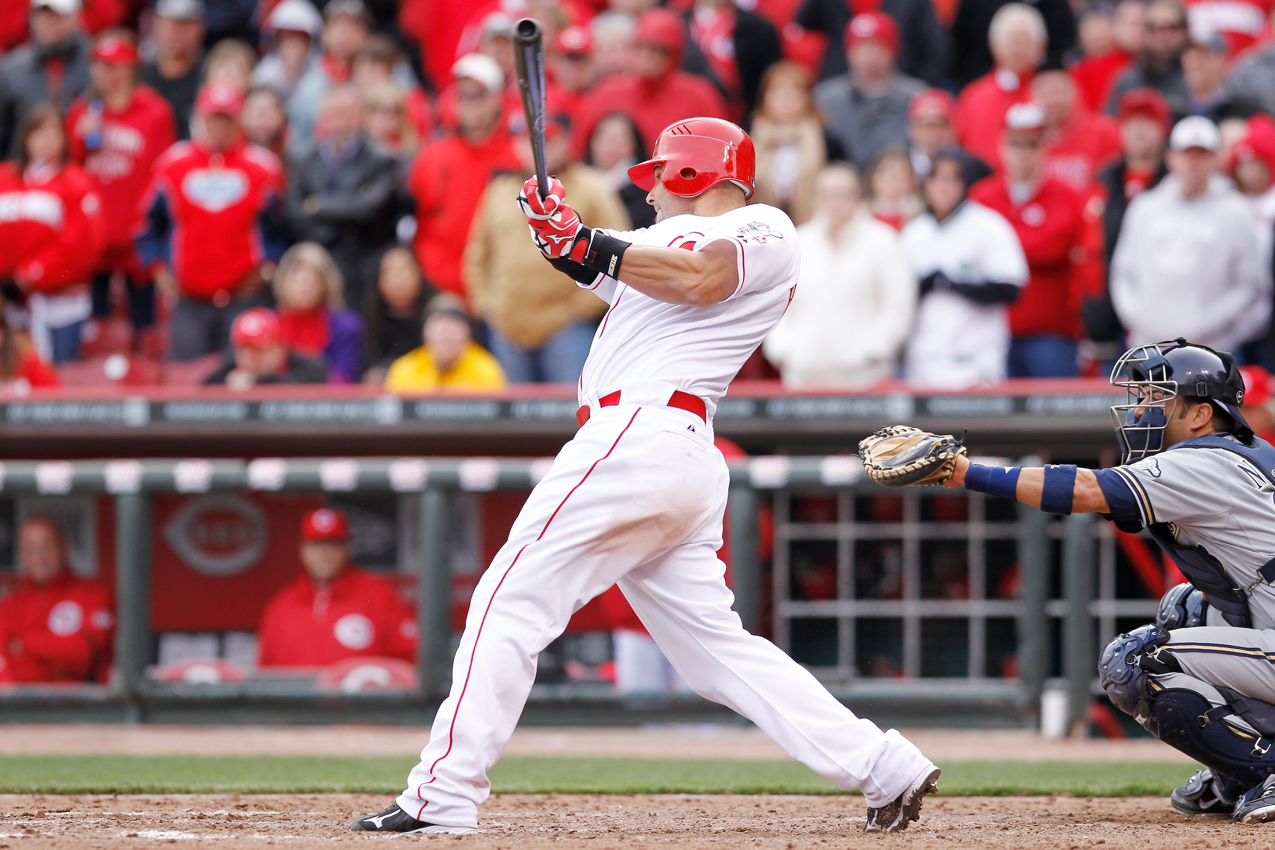 CINCINNATI, OH - MARCH 31: Ramon Hernandez #55 of the Cincinnati Reds hits the game-winning home run in the ninth inning against the Milwaukee Brewers in the opening day game at Great American Ballpark on March 31, 2011 in Cincinnati, Ohio. The Reds won 7