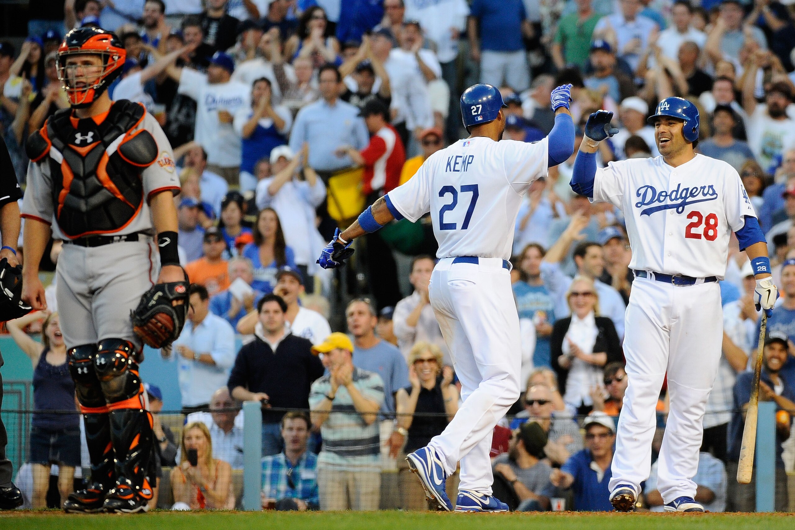 LOS ANGELES, CA - MARCH 31:  Matt Kemp #27 of the Los Angeles Dodgers celebrates with Rod Barajas #28 after scoring on a throwing error by Buster Posey #28 of the San Francisco Giants in the sixth inning of Opening Day at Dodger Stadium on March 31, 2011