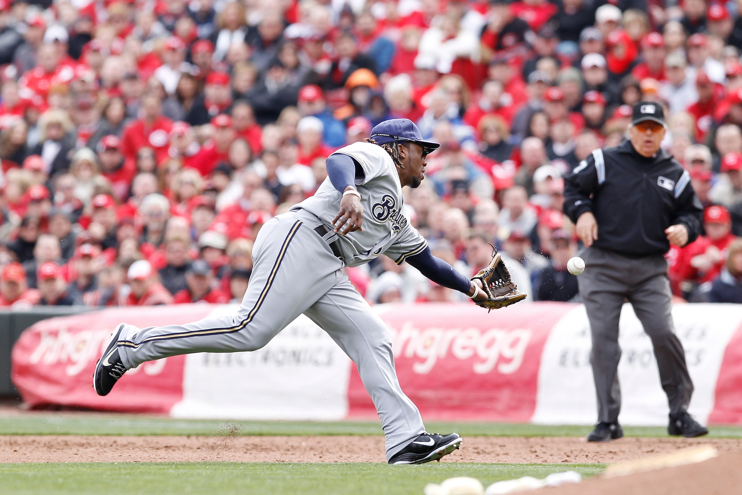 CINCINNATI, OH - MARCH 31: Rickie Weeks #23 of the Milwaukee Brewers flips the ball to first base after fielding a ground ball against the Cincinnati Reds in the opening day game at Great American Ballpark on March 31, 2011 in Cincinnati, Ohio. The Reds w