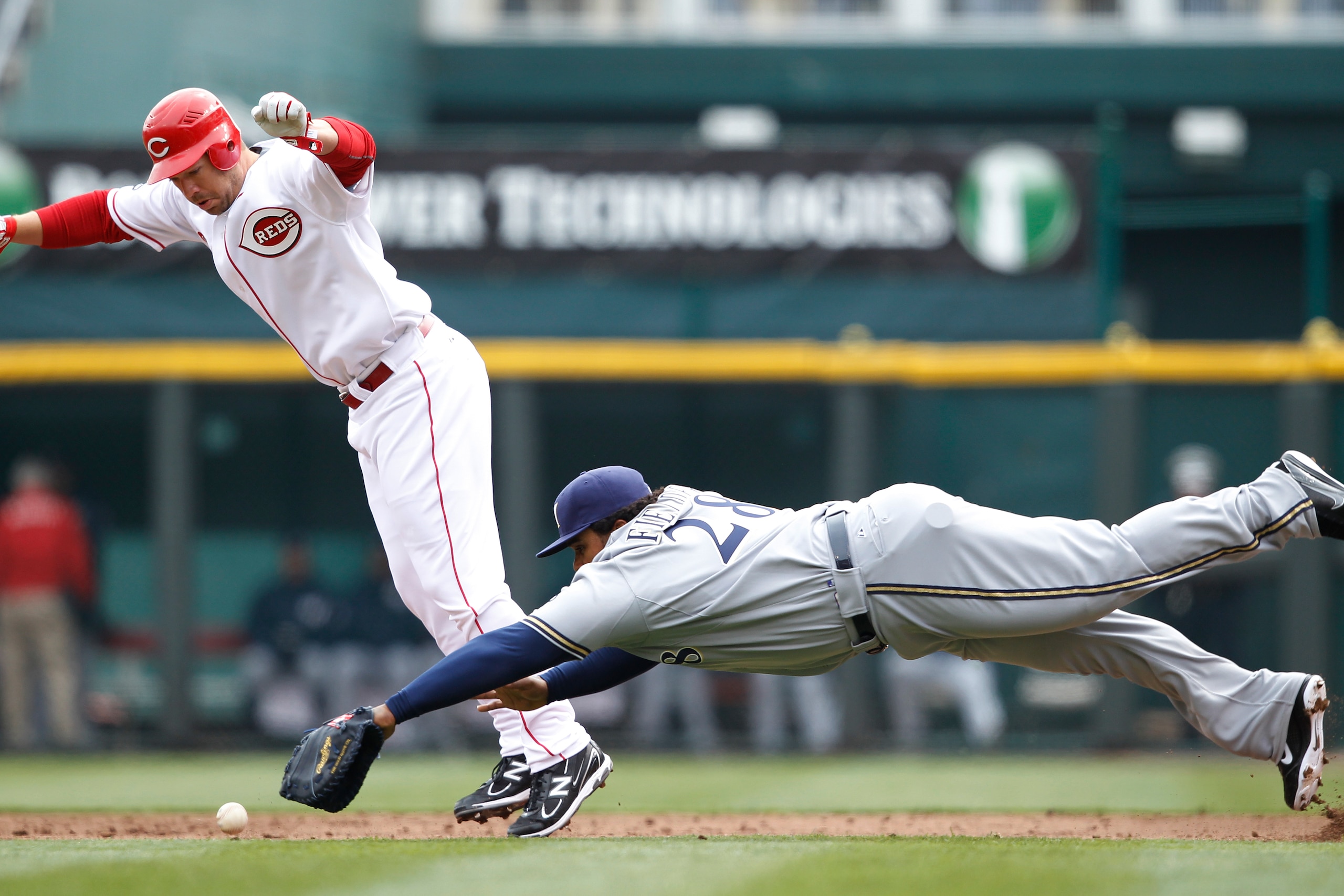 CINCINNATI, OH - MARCH 31: Scott Rolen #27 of the Cincinnati Reds tries to avoid Prince Fielder #28 of the Milwaukee Brewers on a ground ball during the opening day game at Great American Ballpark on March 31, 2011 in Cincinnati, Ohio. (Photo by Joe Robbi