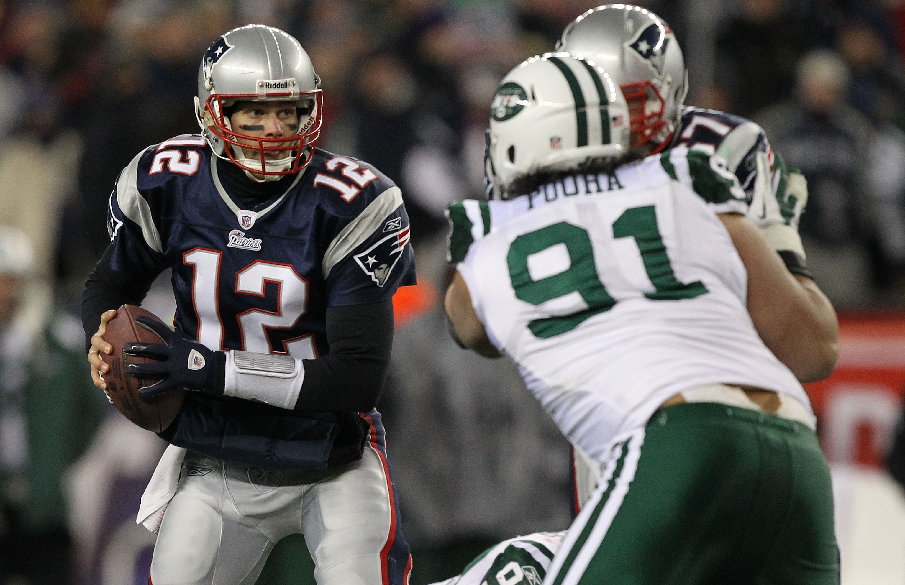 New England Patriots quarterback Tom Brady (12) jokes with New England  Patriots wide receiver Troy Brown before the game against the Jacksonville  Jaguars at Gillette Stadium in Foxboro, Massachusetts on January 12