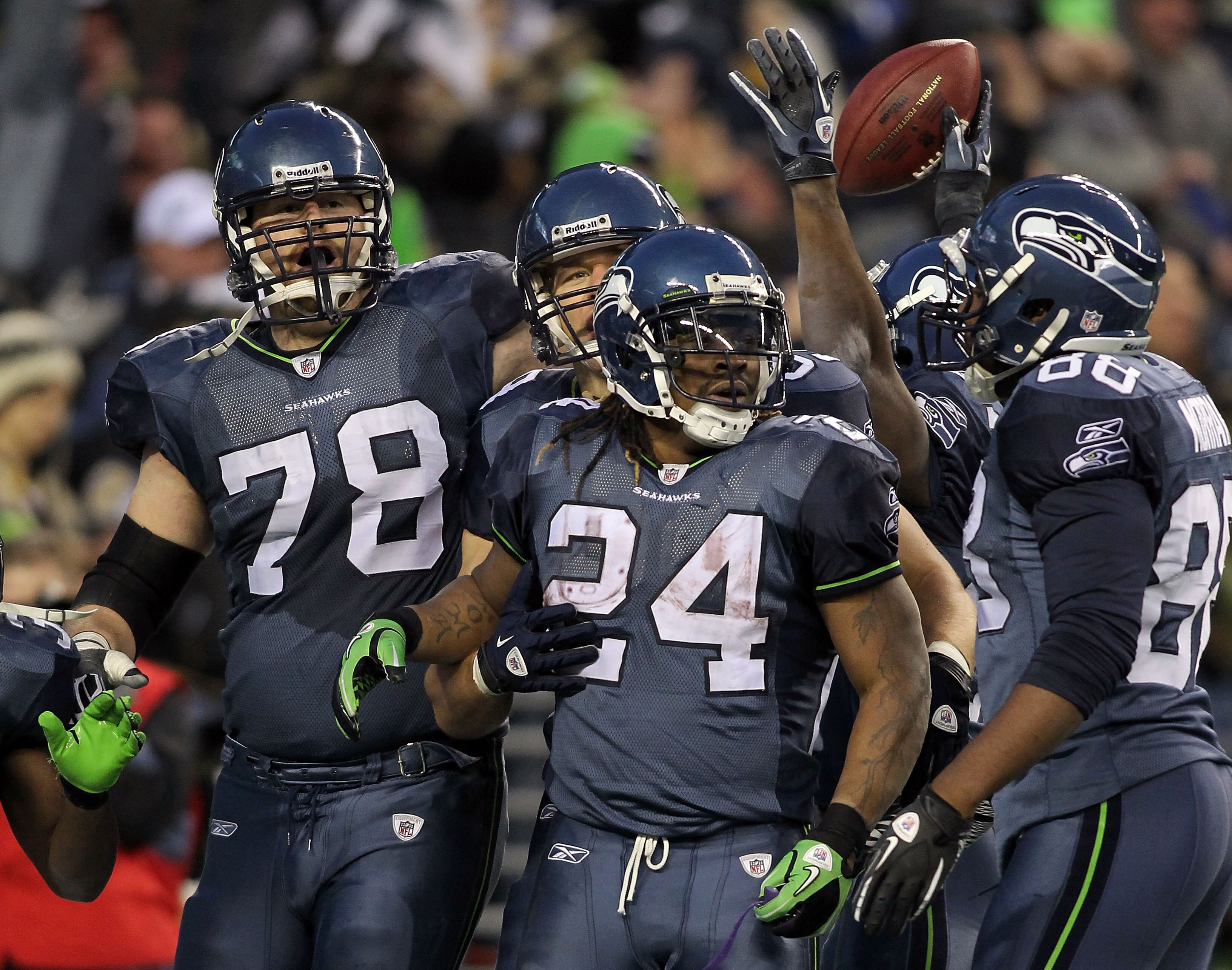SEATTLE, WA - JANUARY 08:  Running back Marshawn Lynch #24 of the Seattle Seahawks celebrates with his teammates his 67-yard touchdown run in the fourth quarter against the New Orleans Saints during the 2011 NFC wild-card playoff game at Qwest Field on Ja