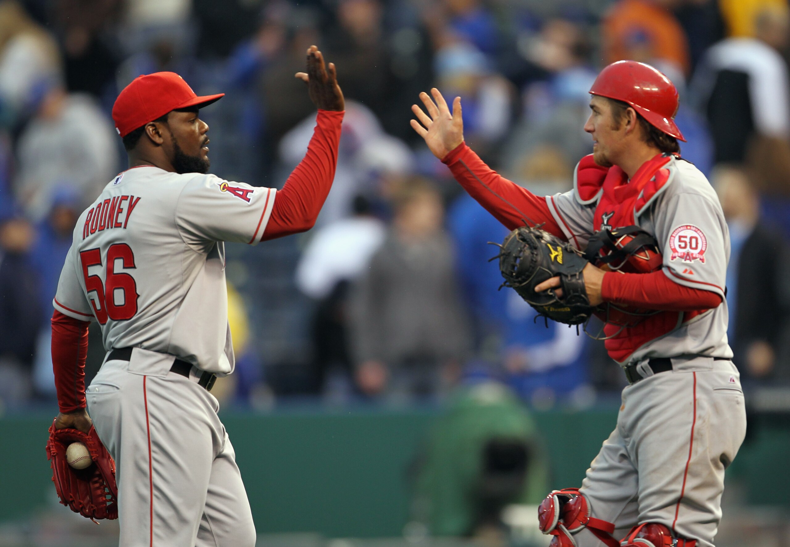 KANSAS CITY, MO - MARCH 31:  Pitcher Fernando Rodney #56 of the Los Angeles Angels of Anaheim is congratulated by catcher Jeff Mathis #5 after the Angels defeated the Kansas City Royals 4-2 to win the opening day game at Kauffman Stadium on March 31, 2011