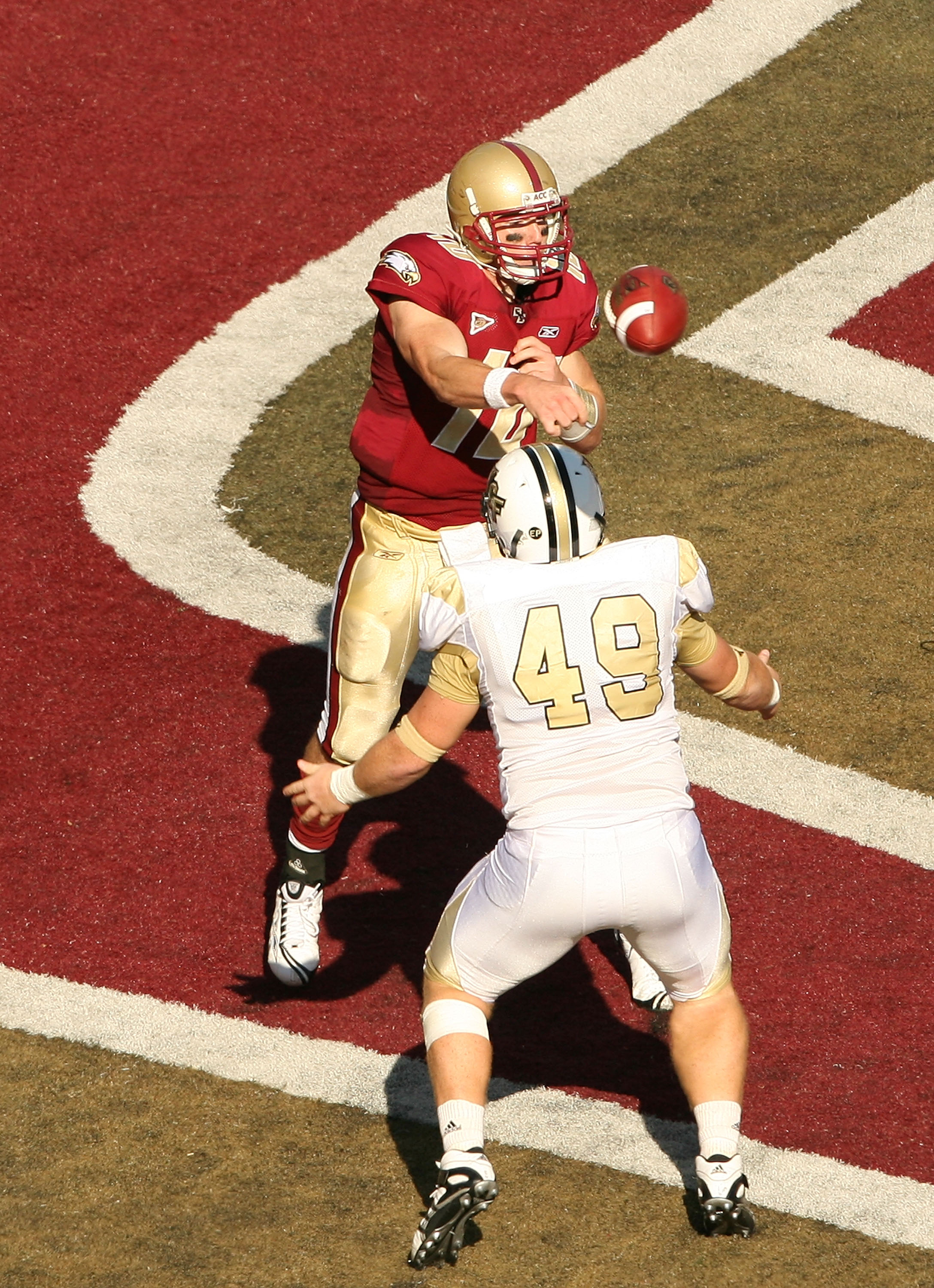 CHESTNUT HILL, MA - SEPTEMBER 20:  Chris Crane #10 of the Boston College Eagles passes under pressure from Bruce Miller #49 of the Central Florida Knights on September 20, 2008 at Alumni Stadium in Chestnut Hill, Massachusetts. The Eagles defeated the Kni