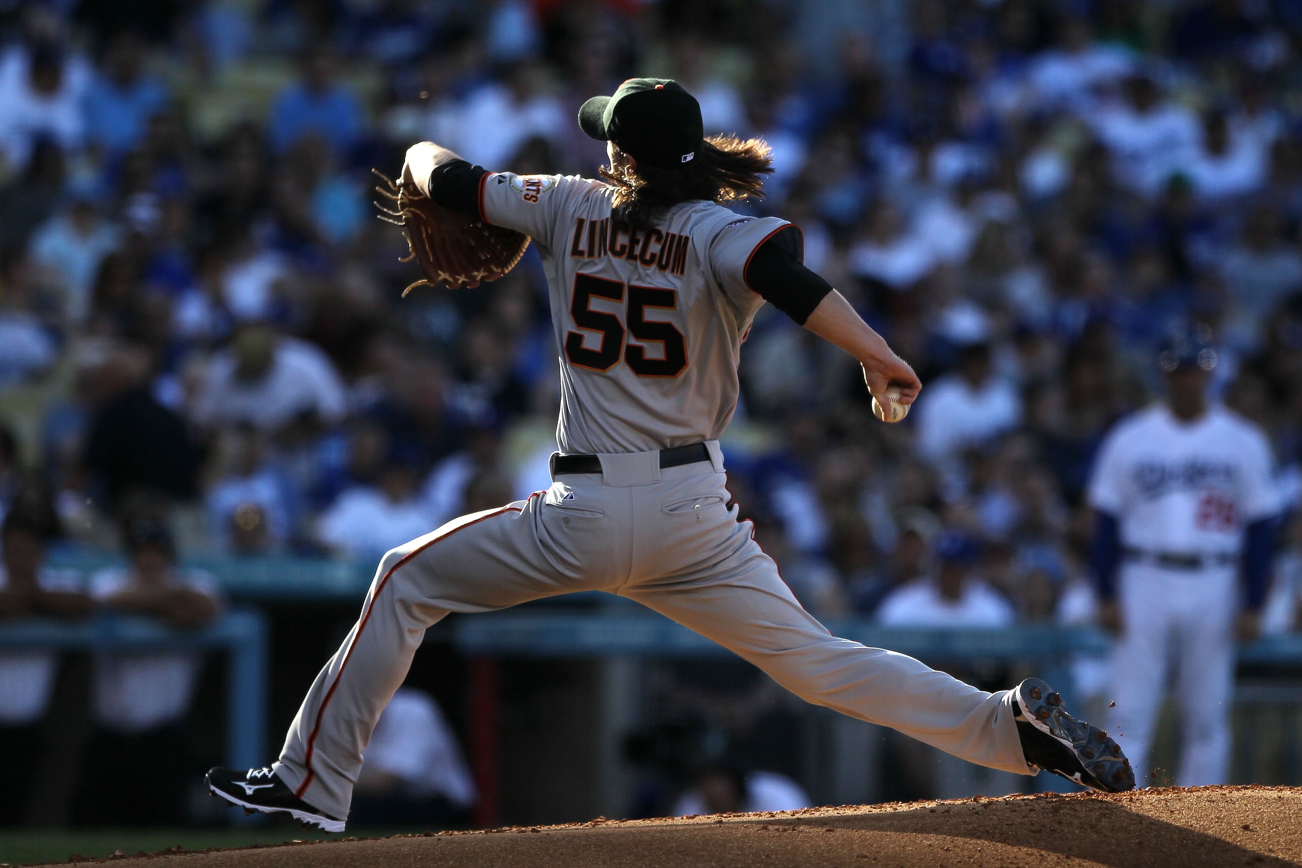 LOS ANGELES, CA - MARCH 31:  Tim Lincecum #55 of the San Francisco Giants throws a pitch against the Los Angeles Dodgers on Opening Day at Dodger Stadium on March 31, 2011 in Los Angeles, California.  (Photo by Jeff Gross/Getty Images)