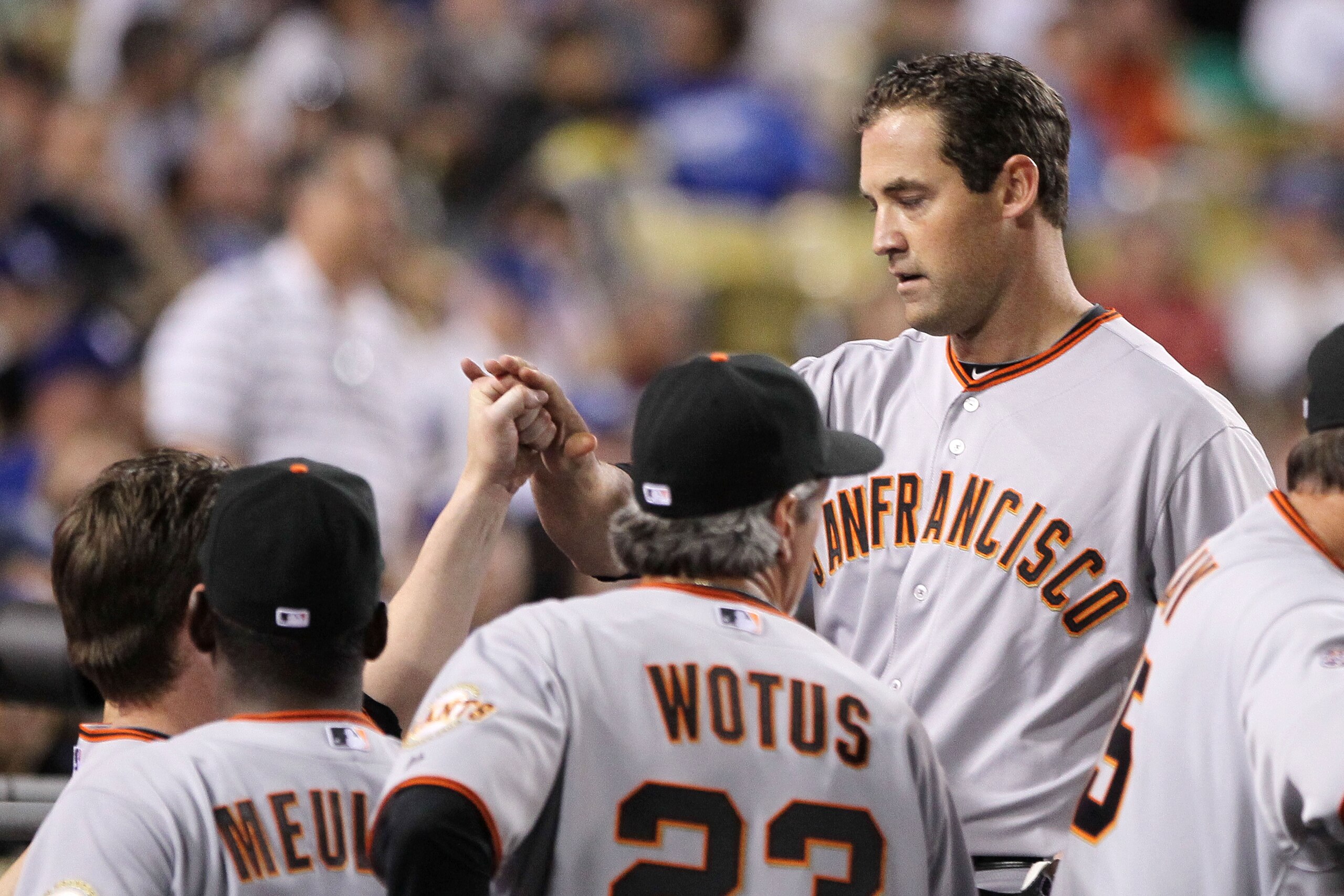LOS ANGELES, CA - MARCH 31:  Pat Burrell #5 of the San Francisco Giants celebrates with teammates after hitting a home run in the ninth inning against the Los Angeles Dodgers on Opening Day at Dodger Stadium on March 31, 2011 in Los Angeles, California.