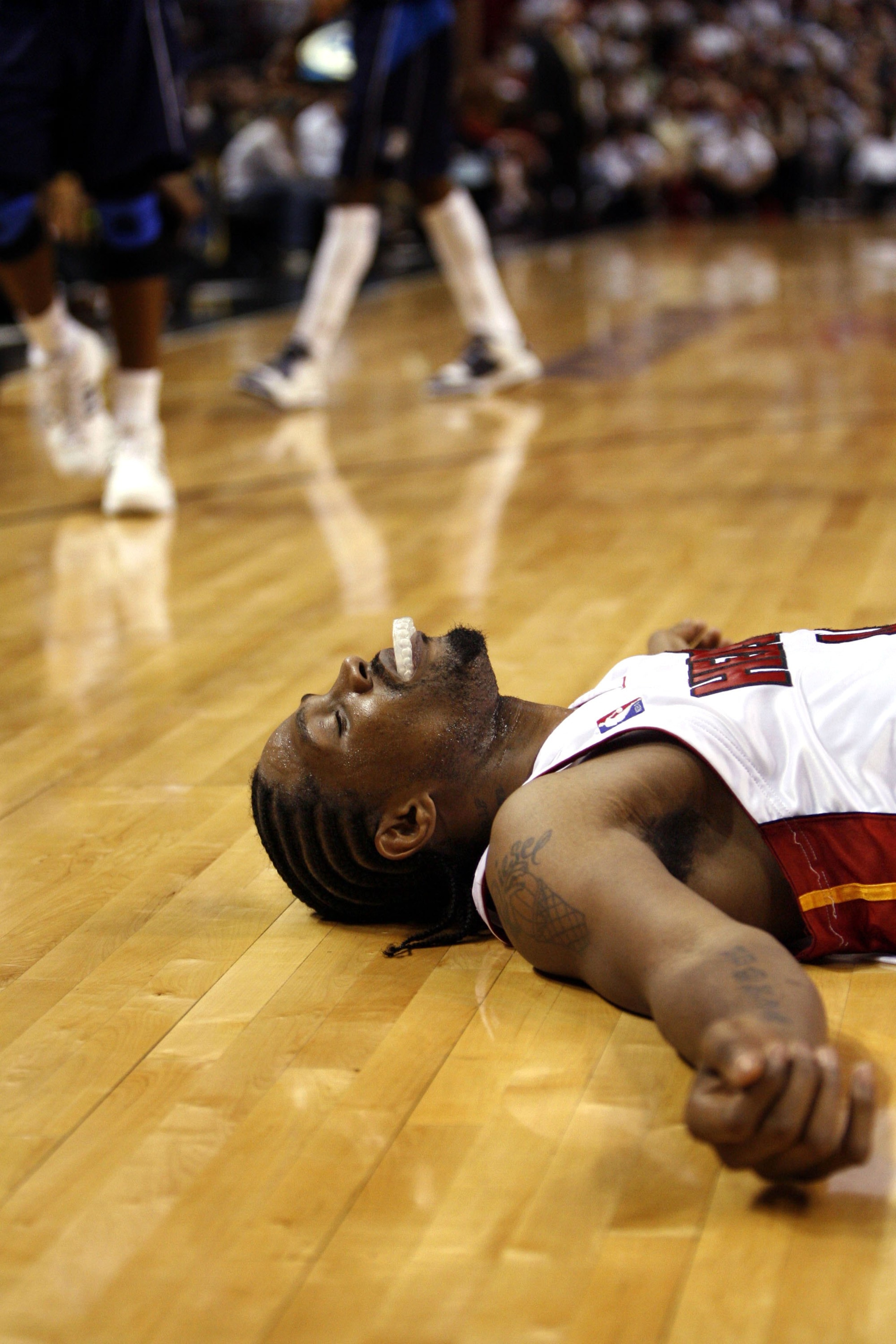 MIAMI - JANUARY 21:  Forward Udonis Haslem #40 of the Miami Heat lies on the court after being fouled against the Dallas Mavericks in the fourth period on January 21, 2007 at the American Airlines Arena in Miami  Florida.  NOTE TO USER: User expressly ack
