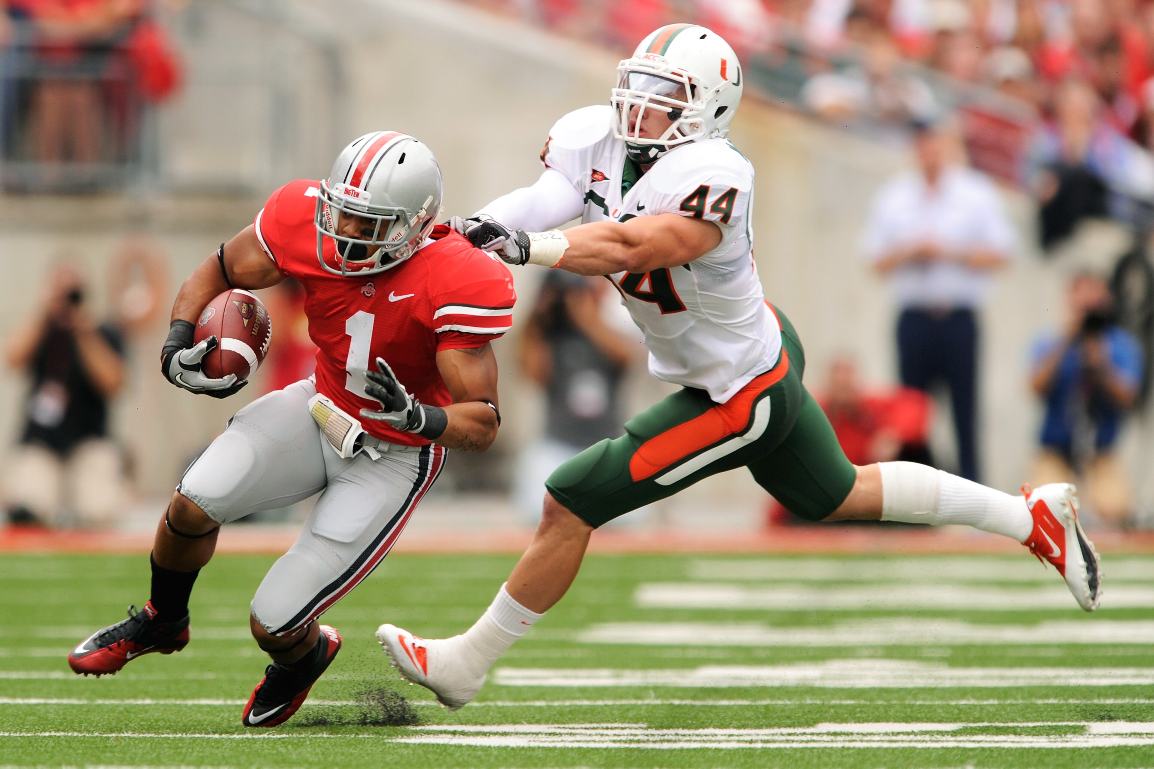 COLUMBUS, OH - SEPTEMBER 11: Colin McCarthy #44 of the Miami Hurricanes attempts to tackle Dan Herron #1 of the Ohio State Buckeyes at Ohio Stadium on September 11, 2010 in Columbus, Ohio. (Photo by Jamie Sabau/Getty Images) COLUMBUS, OH - SEPTEMBER 11: Colin McCarthy #44 of the Miami Hurricanes attempts to tackle Dan Herron #1 of the Ohio State Buckeyes at Ohio Stadium on September 11, 2010 in Columbus, Ohio. (Photo by Jamie Sabau/Getty Images)