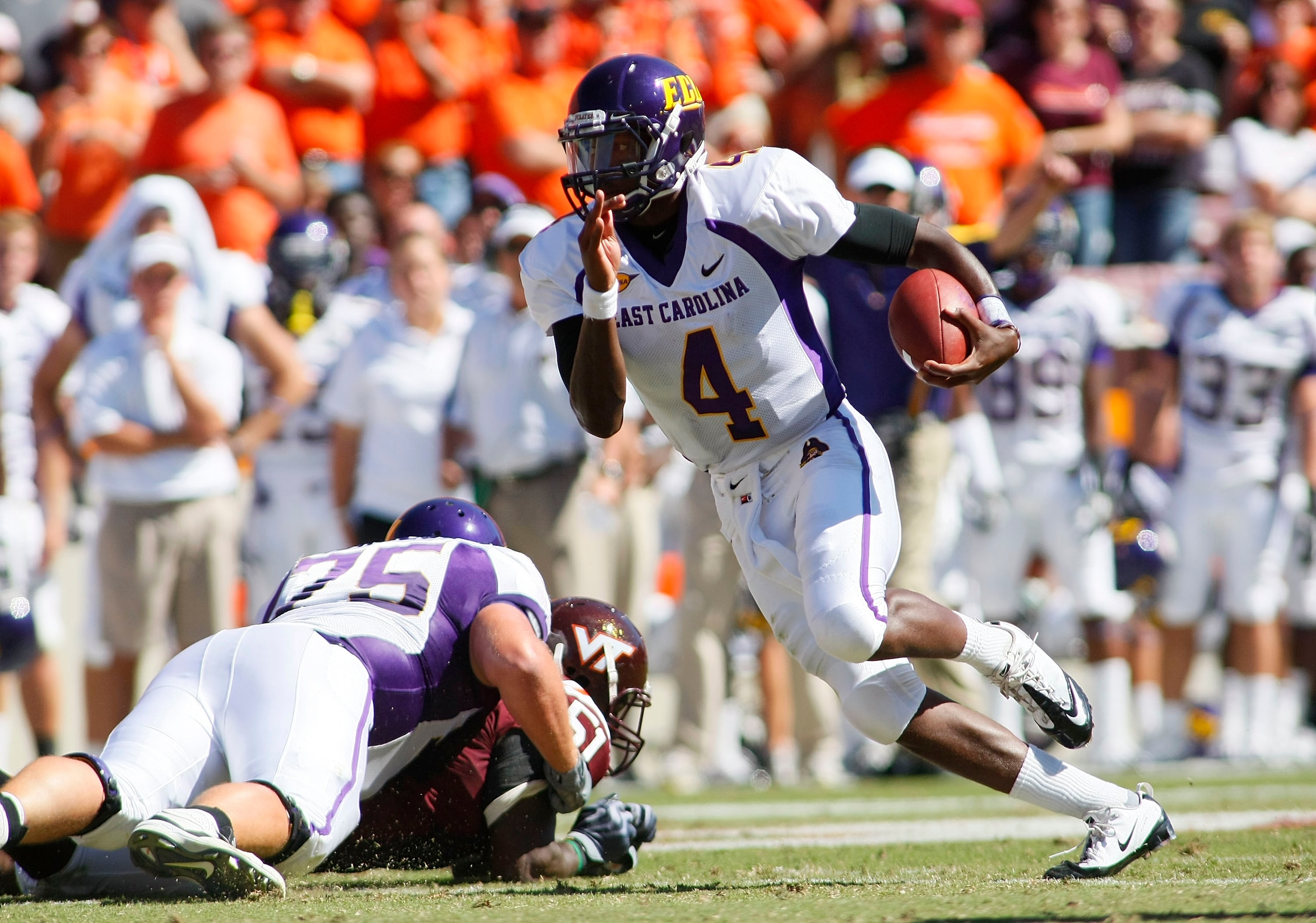 BLACKSBURG, VA - SEPTEMBER 18:  Quarterback Dominique Davis #4 of the East Carolina Pirates runs with the ball against the Virginia Tech Hokies at Lane Stadium on September 18, 2010 in Blacksburg, Virginia.  (Photo by Geoff Burke/Getty Images)