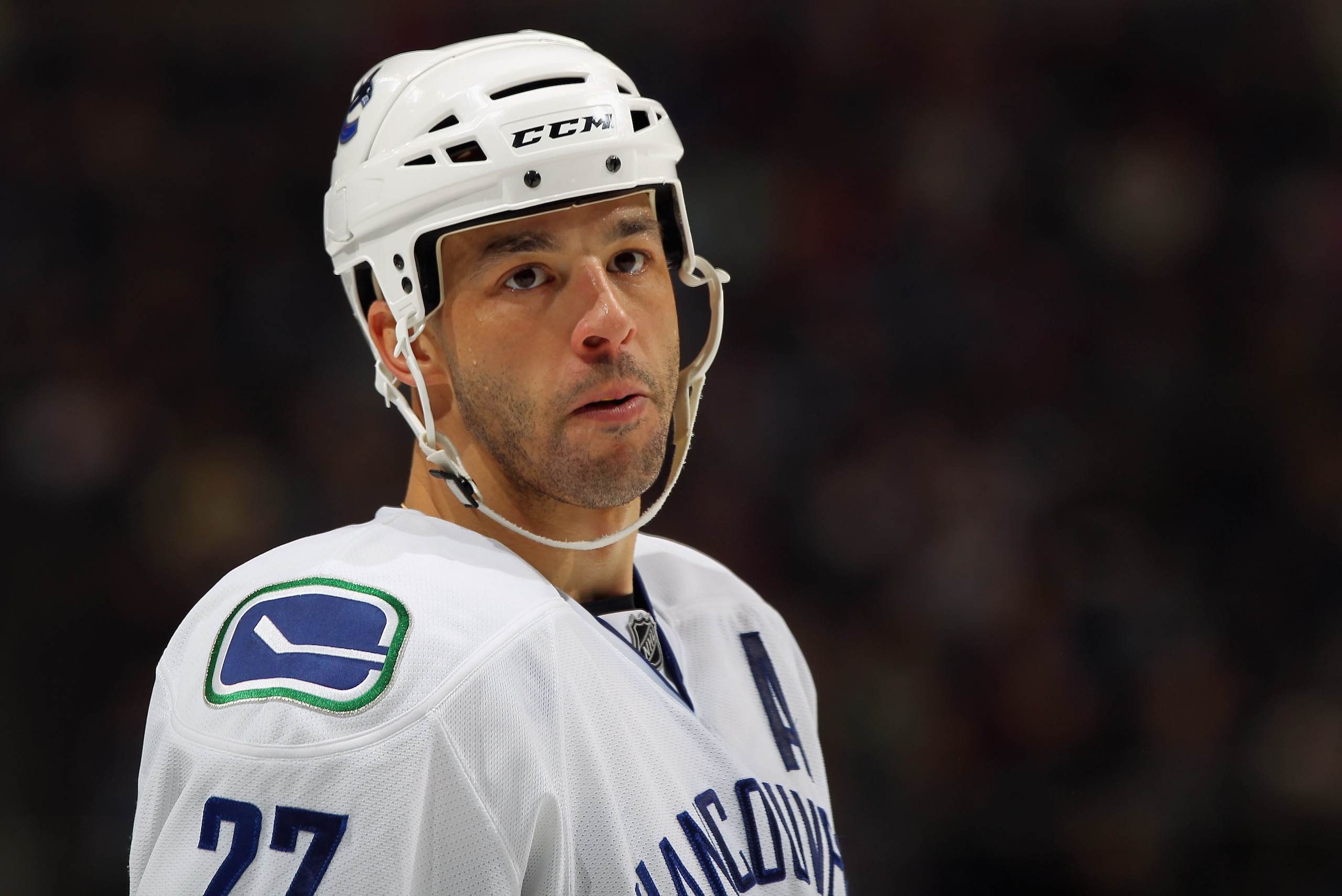 DENVER, CO - JANUARY 18:  Manny Malhotra #27 of the Canucks looks on during a break in the action against the Colorado Avalanche at the Pepsi Center on January 18, 2011 in Denver, Colorado. The Avalanche defeated the Canucks 4-3 in overtime.  (Photo by Do