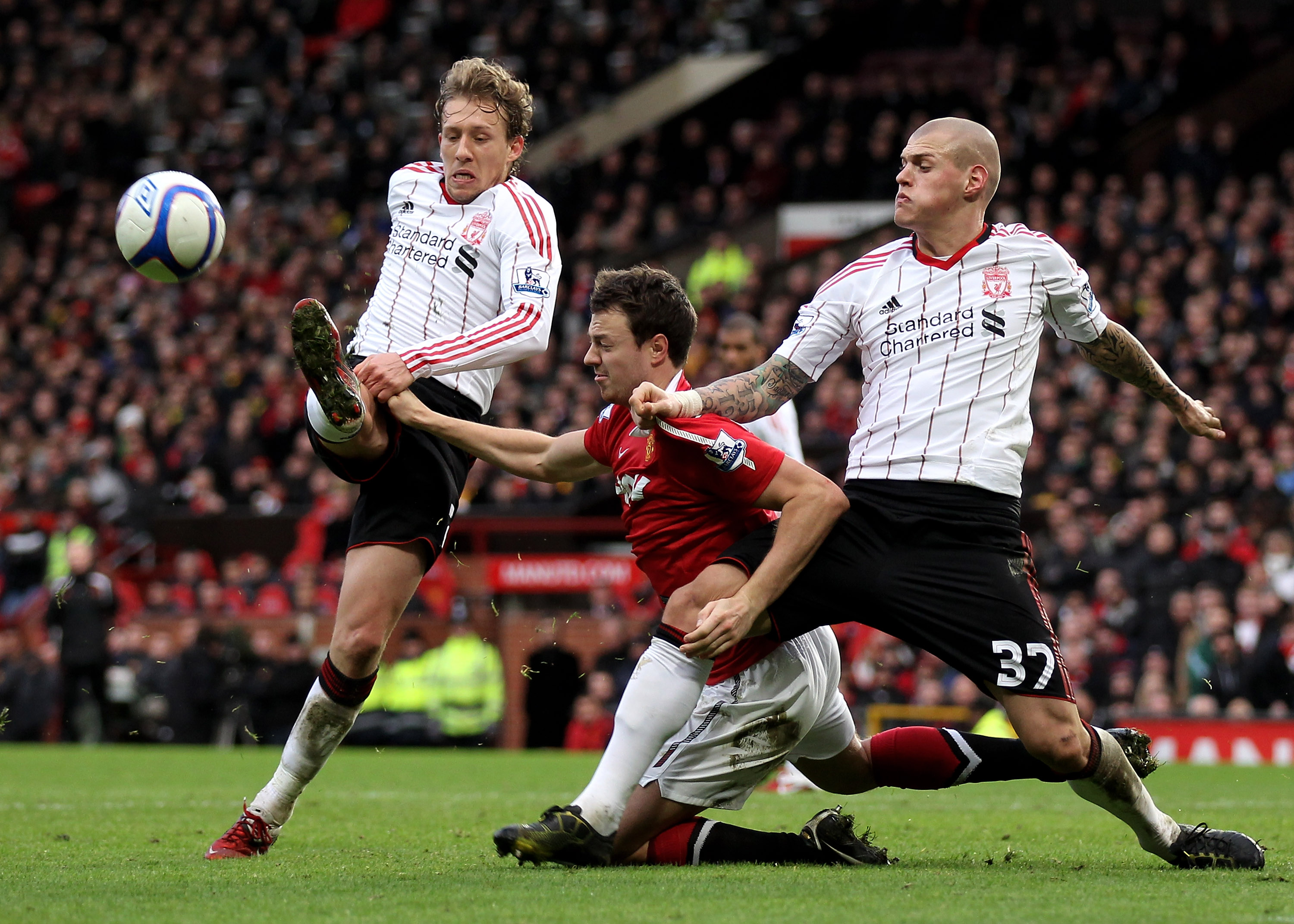 MANCHESTER, ENGLAND - JANUARY 09:  Jonny Evans of Manchester United tangles with Martin Skrtel of Liverpool in the penalty area during the FA Cup sponsored by E.ON 3rd round match between Manchester United and Liverpool at Old Trafford on January 9, 2011
