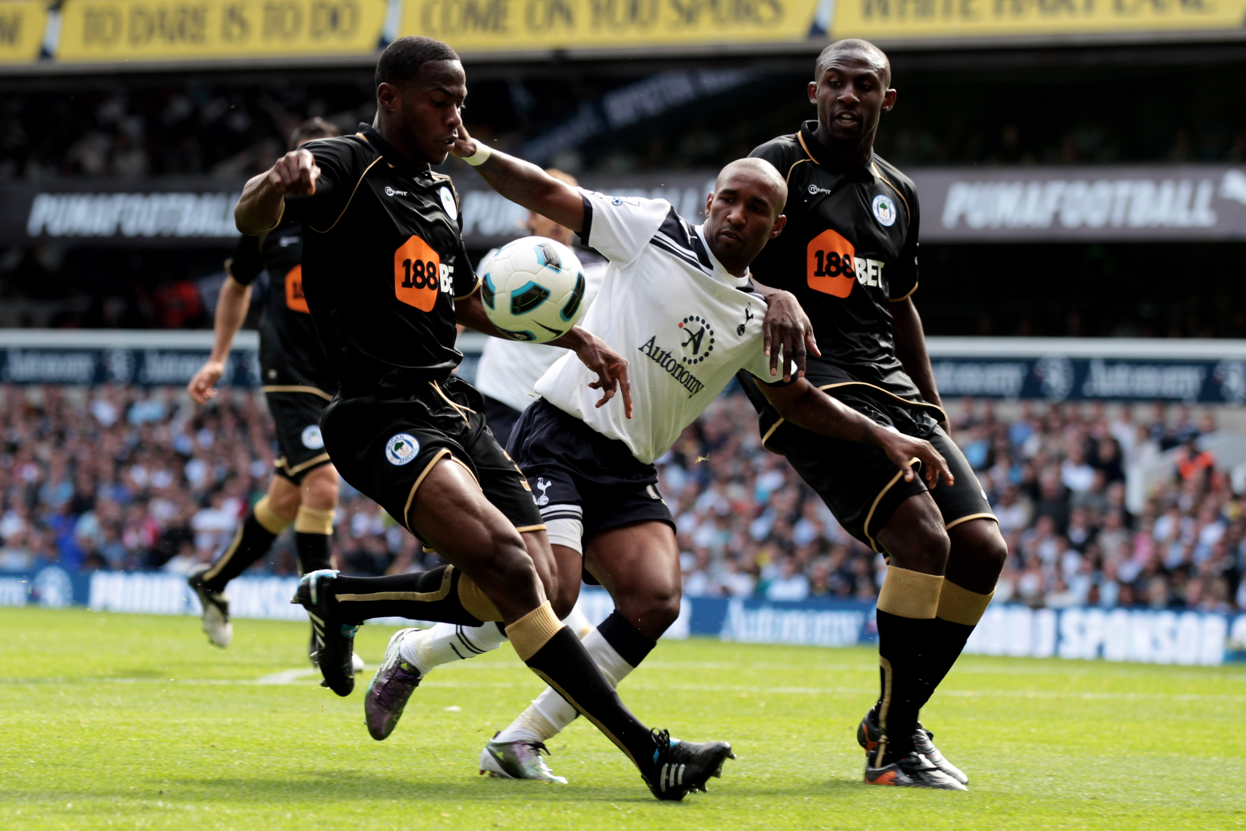LONDON, ENGLAND - AUGUST 28:  Jermain Defoe of Tottenham battles for the ball with Steve Gohouri and Maynor Figueroa of Wigan during the Barclays Premier League match between Tottenham Hotspur and Wigan Athletic at White Hart Lane on August 28, 2010 in Lo