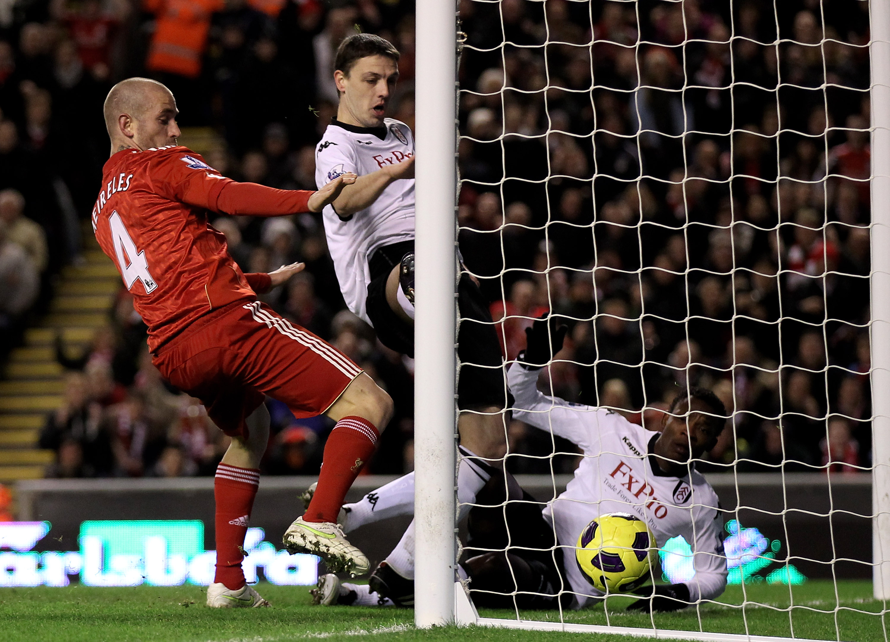 LIVERPOOL, ENGLAND - JANUARY 26:  John Pantsil of Fulham scores an own goal during the Barclays Premier League match between Liverpool and Fulham at Anfield on January 26, 2011 in Liverpool, England.  (Photo by Alex Livesey/Getty Images)