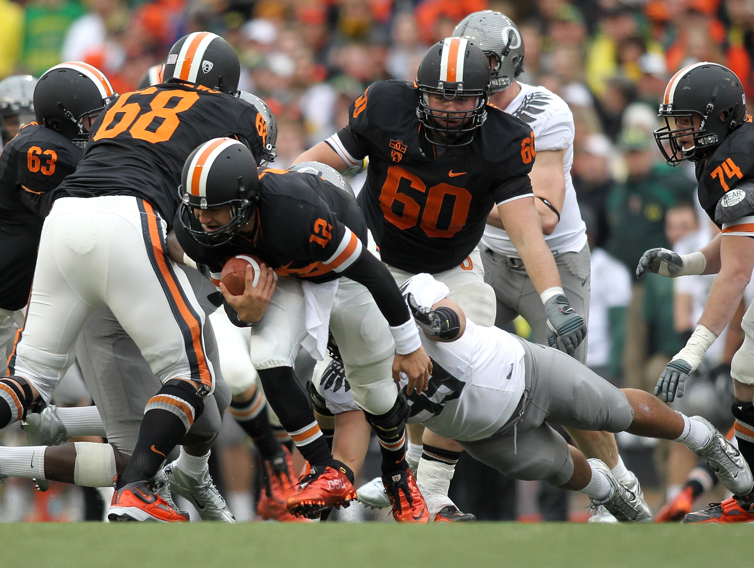 CORVALLIS, OR - DECEMBER 04:  Quarterback Ryan Katz #12 of the Oregon State Beavers is sacked by Casey Matthews #55 of  the Oregon Ducks during the 114th Civil War on December 4, 2010 at the Reser Stadium in Corvallis, Oregon.  (Photo by Jonathan Ferrey/G