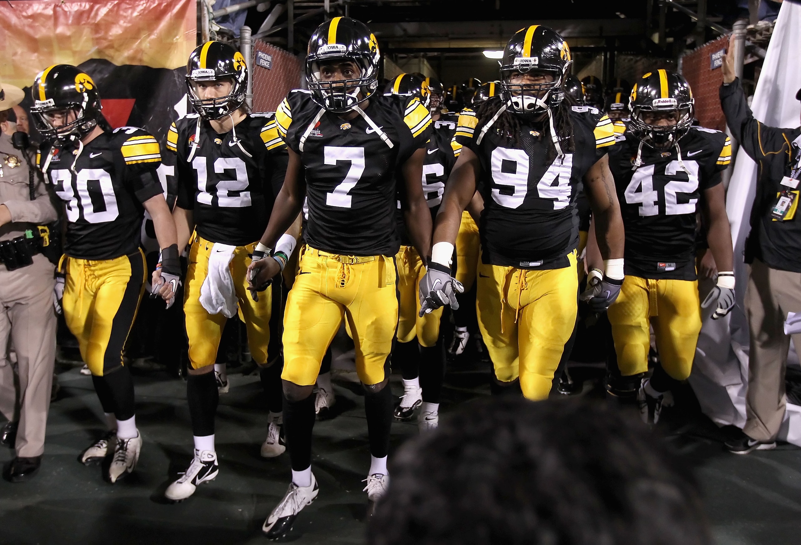 TEMPE, AZ - DECEMBER 28:  (L-R) De'Andre Johnson #30, Ricky Stanzi #12, Marvin McNutt #7, Adrian Clayborn #94 and Jeremiha Hunter #42 of the Iowa Hawkeyes walk out onto the field for the Insight Bowl against the Missouri Tigers at Sun Devil Stadium on Dec