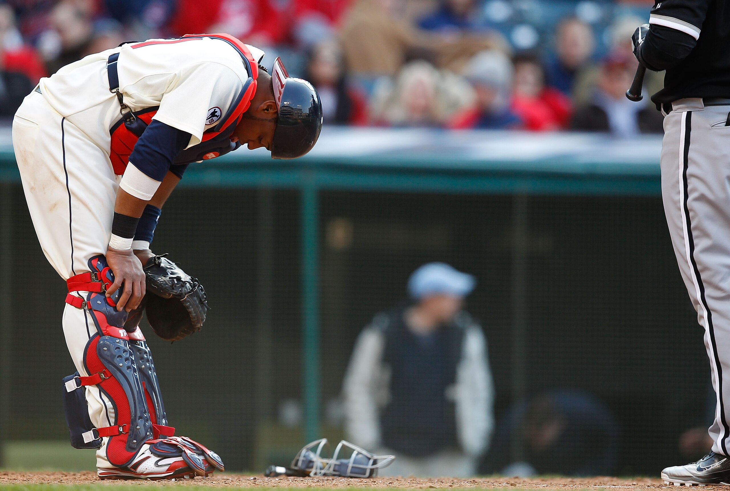 CLEVELAND - APRIL 01: Carlos Santana #41 of the Cleveland Indians has a moment to himself after getting hit near the neck with a pitch against the Chicago White Sox during the Opening Day game on April 1, 2011 at Progressive Field in Cleveland, Ohio.  (Ph