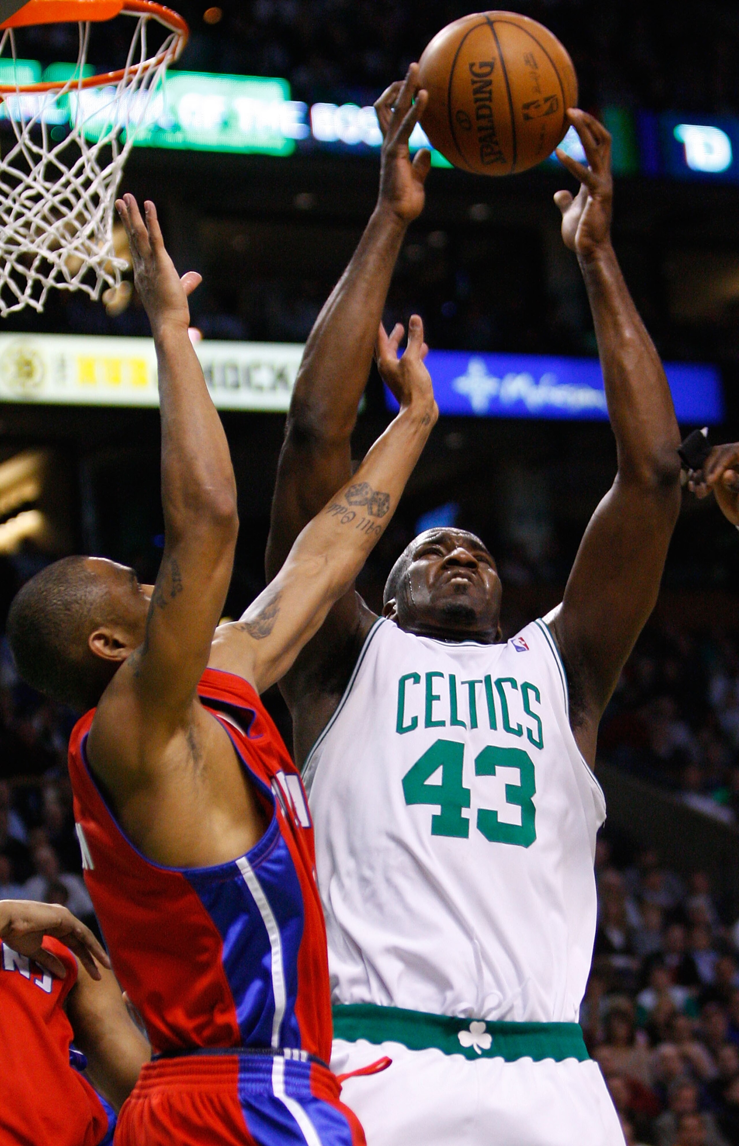BOSTON, MA - MARCH 5:  Kendrick Perkins #43 of the Boston Celtics grabs a rebound from Juan Dixon #8 of the Detroit Pistons at the TD Banknorth Garden on March 5, 2008 in Boston, Massachusetts. NOTE TO USER: User expressly acknowledges and agrees that, by