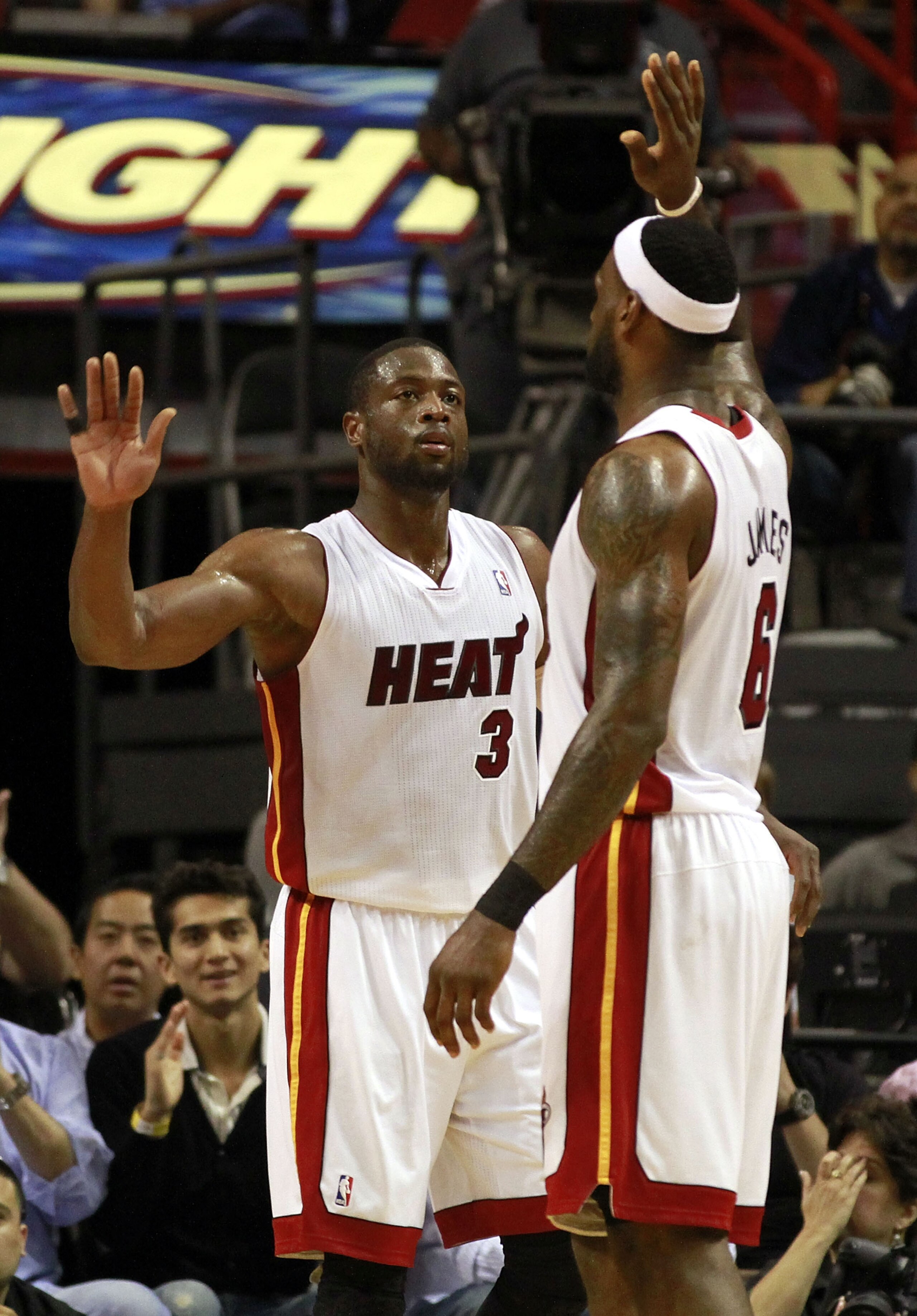 MIAMI, FL - MARCH 25:  Guard Dwyane Wade #3 and Forward LeBron James #6 of the Miami Heat celebrate against the Philadelphia Sixers at American Airlines Arena on March 25, 2011 in Miami, Florida. NOTE TO USER: User expressly acknowledges and agrees that,